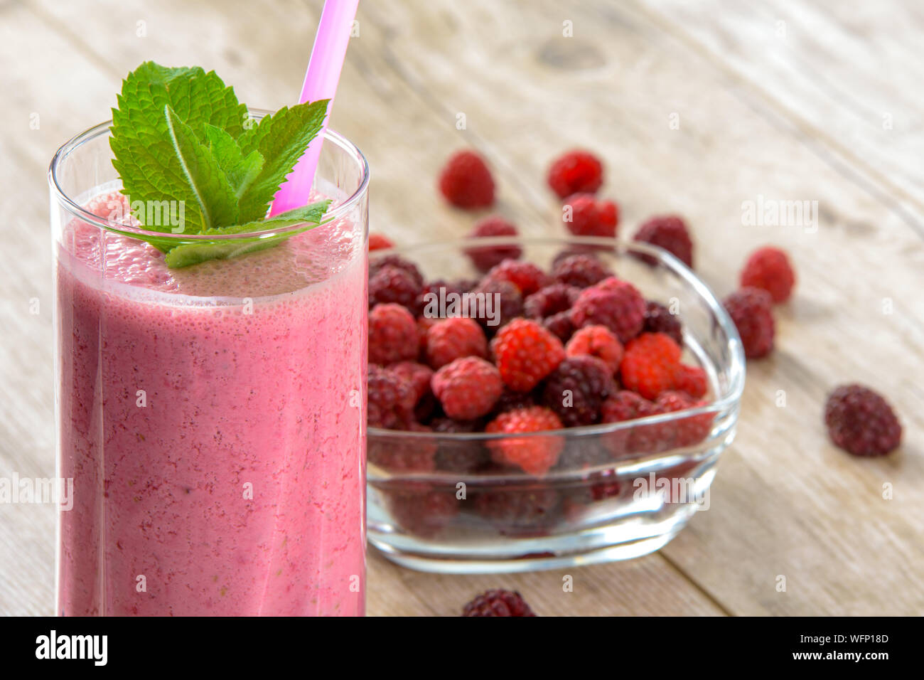 Close-up Of Raspberry Smoothie In Glass On Table Stock Photo