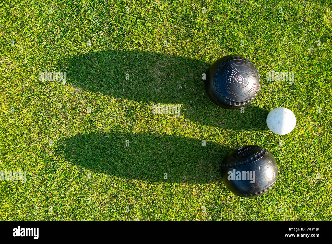 Bowling balls near the jack ball seen from above in a lawn bowls