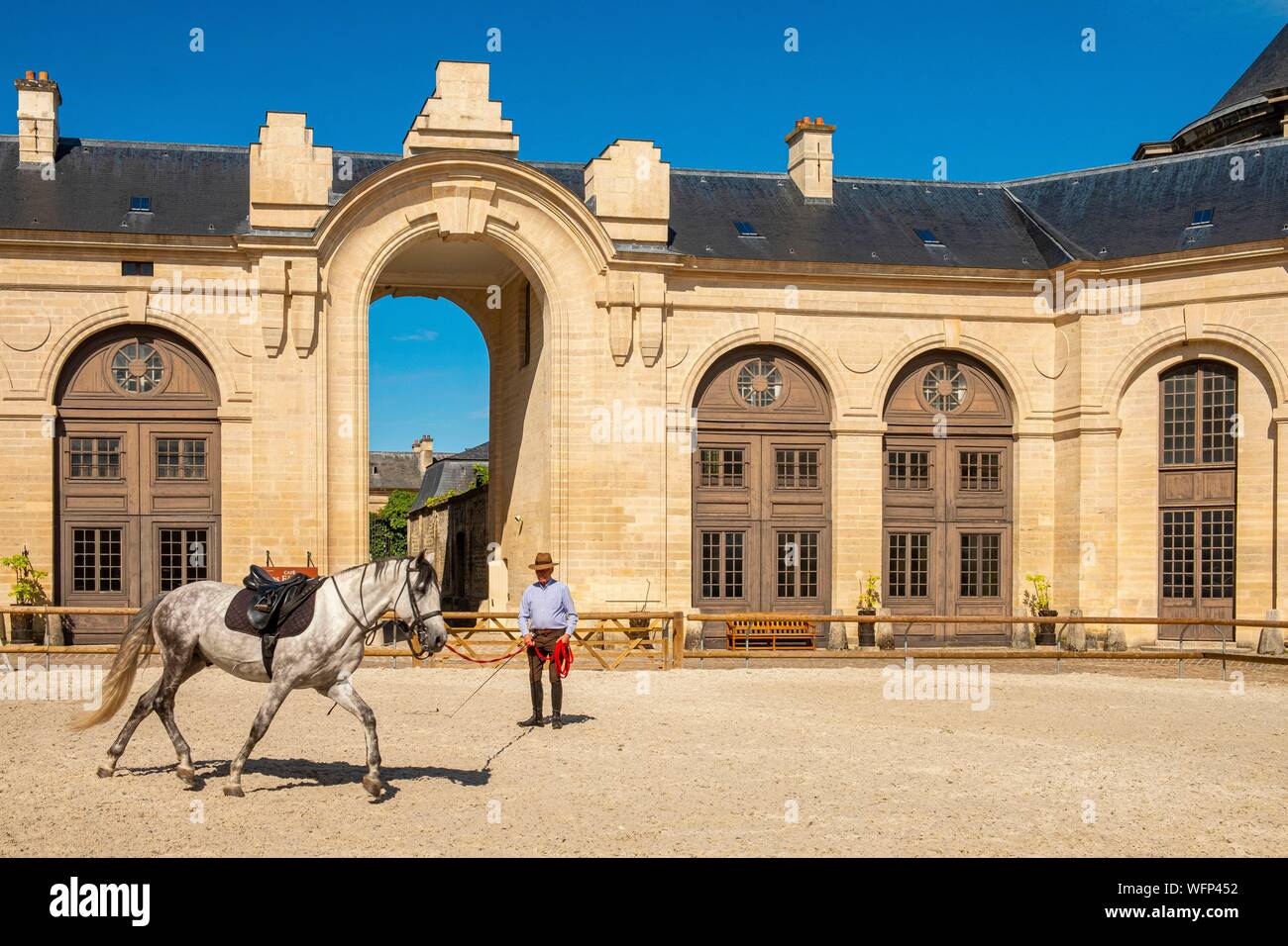 France, Oise, Chantilly, Chantilly Castle, the Great Stables, rider training his horse in the carousel Stock Photo