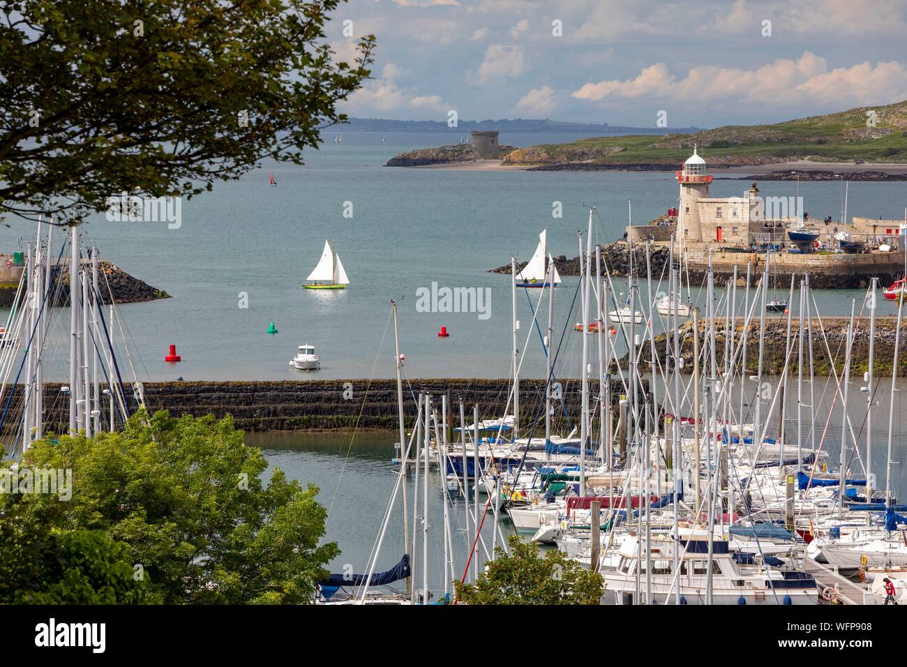 Ireland, Fingal County, Northern Dublin Suburbs, Howth, Fishing and Yachting Harbor and Howth Lighthouse Stock Photo