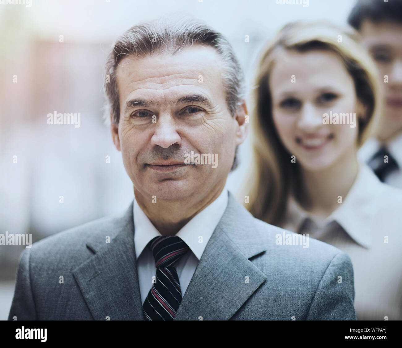 Happy smiling business team standing in a row at office Stock Photo - Alamy
