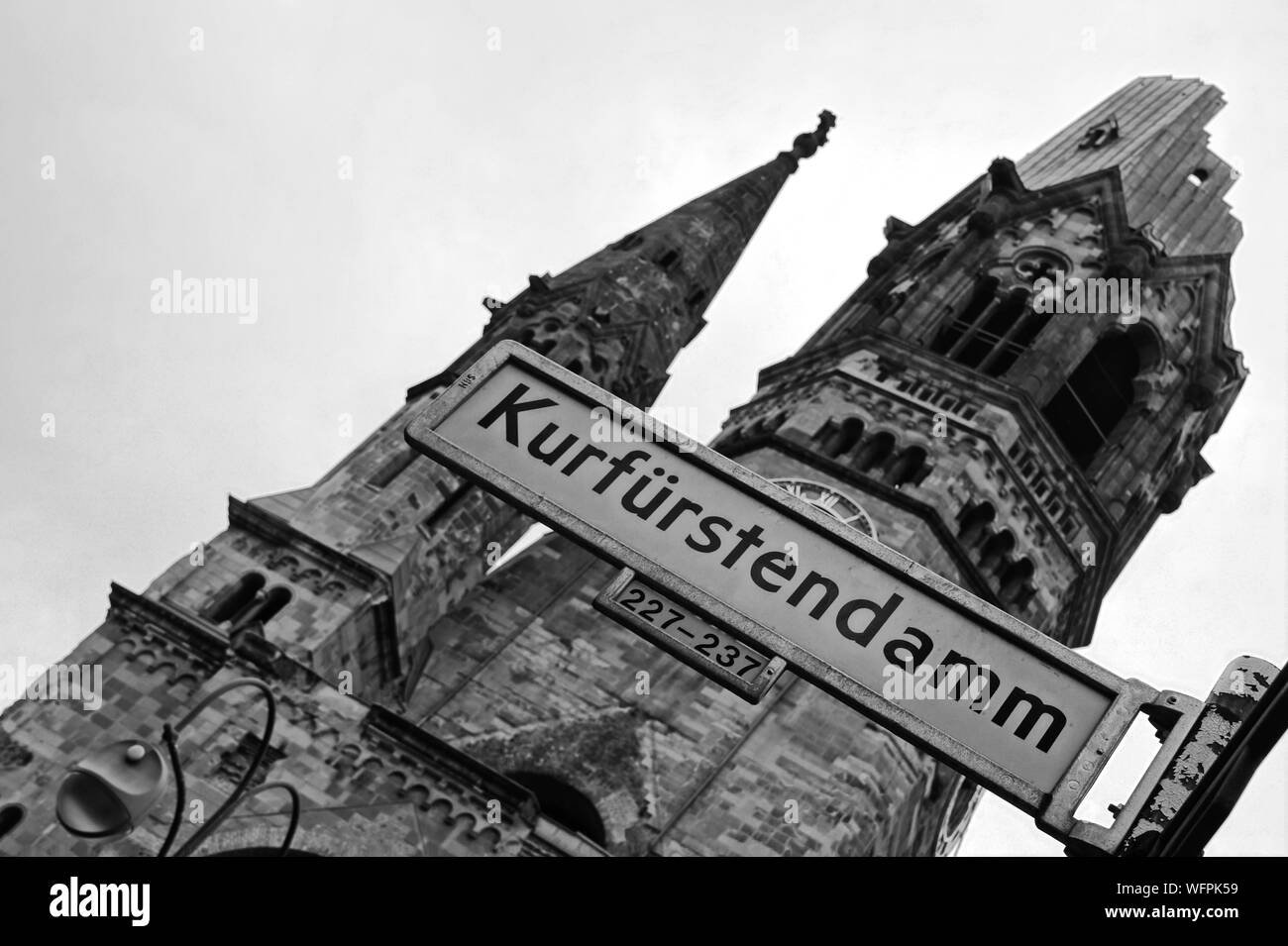 Low Angle View Of Kurfurstendamm Sign Against Kaiser Wilhelm Memorial Church Stock Photo