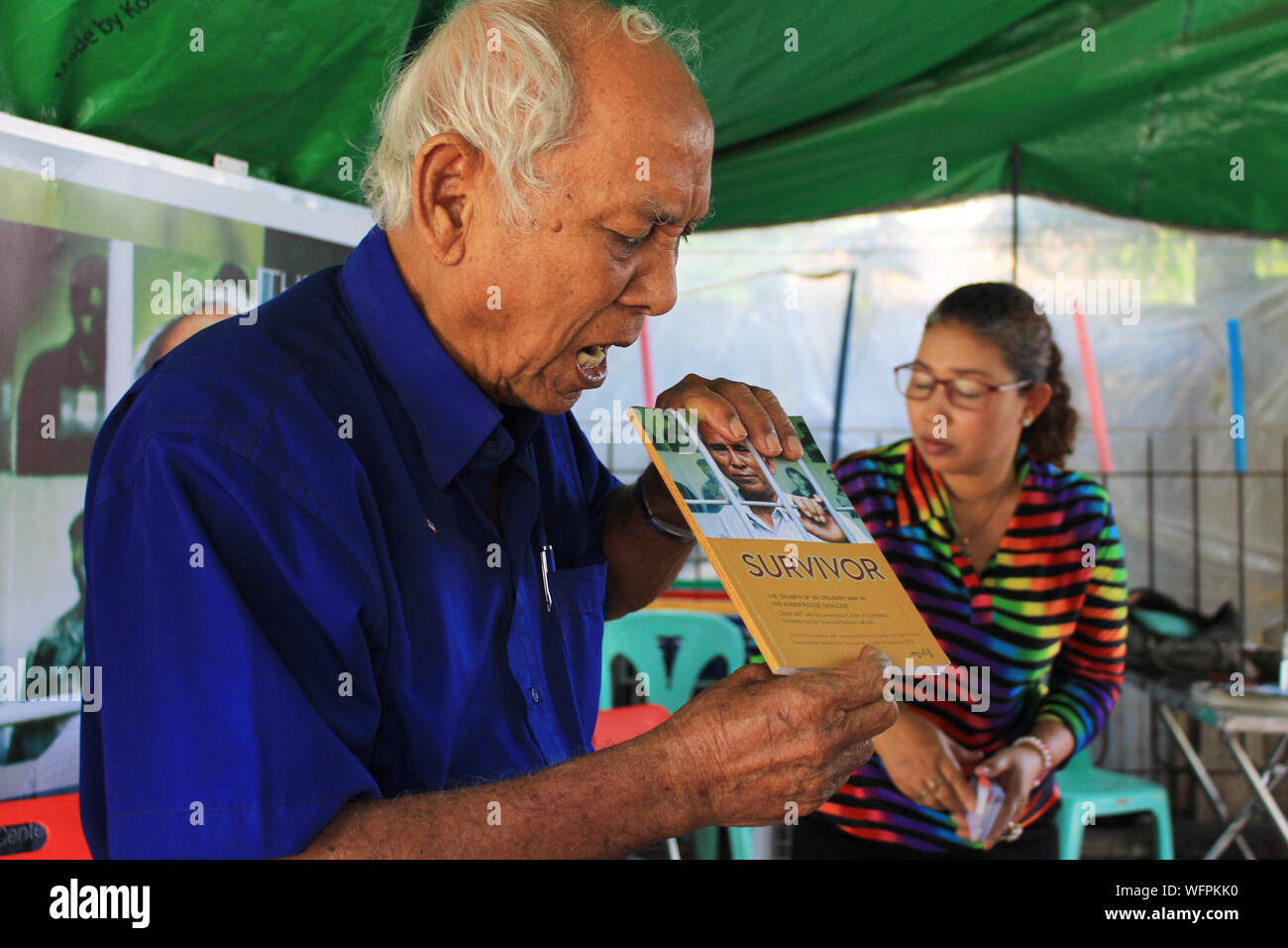Phnom Penh, Cambodia - june 4 2019 -  Chum Mey , one of the survivors of Khmer Rouge Genocide prison s21 with his autobiography book Stock Photo