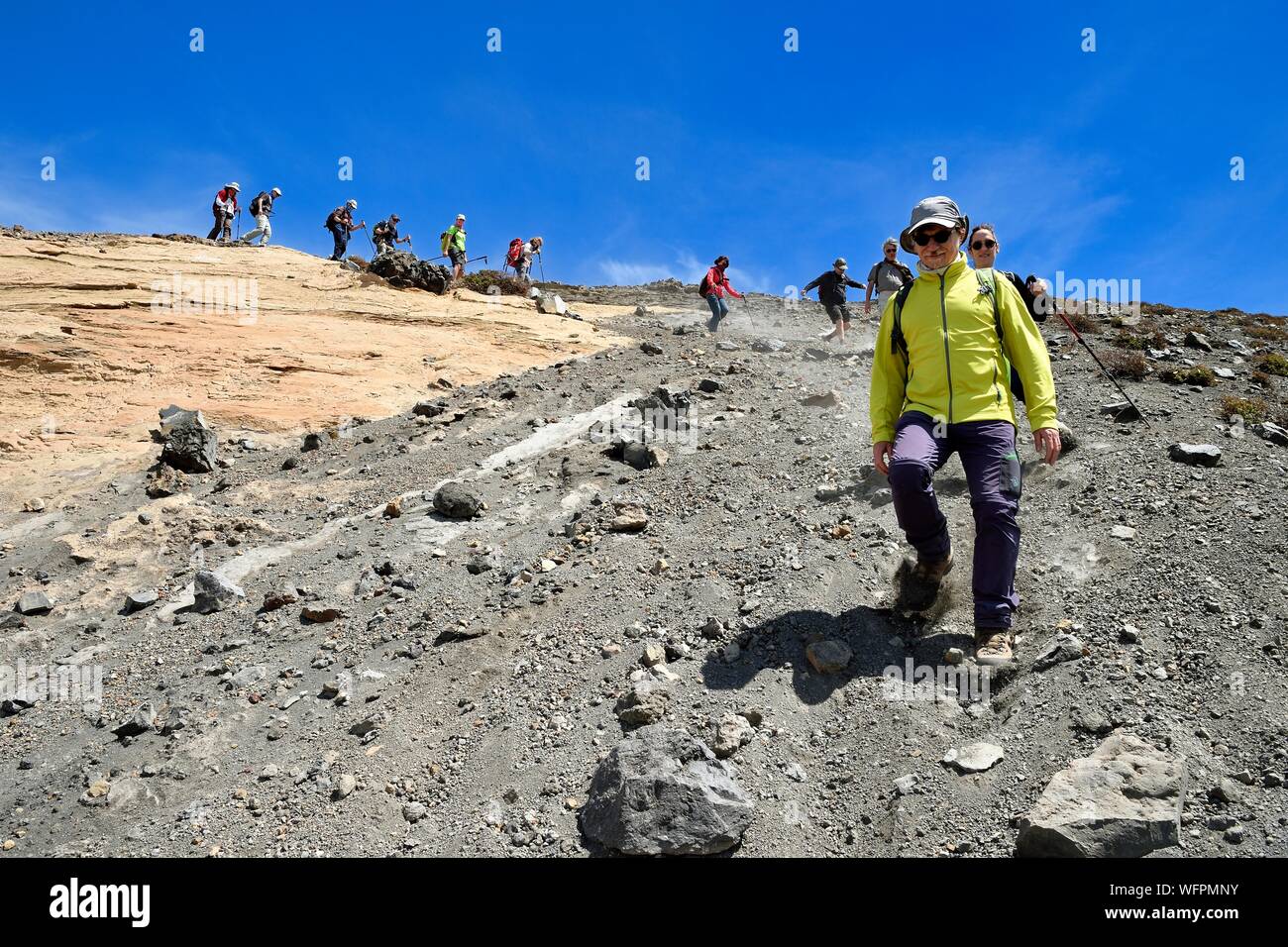 Italy, Sicily, Aeolian Islands, listed as World Heritage by UNESCO, Vulcano Island, hikers descending the crater flanks of volcano della Fossa Stock Photo