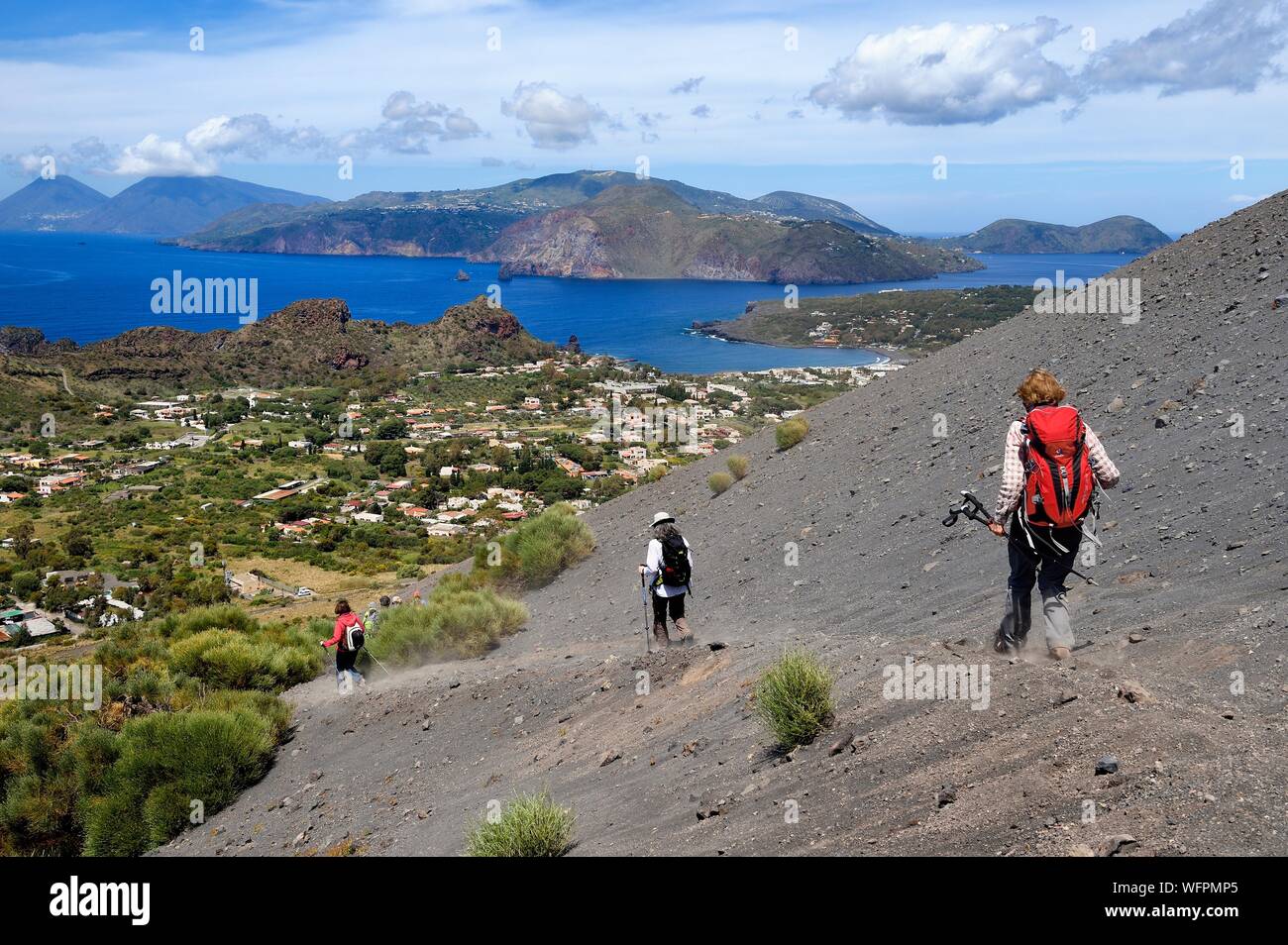 Italy, Sicily, Aeolian Islands, listed as World Heritage by UNESCO, Vulcano Island, hikers on the flanks of the crater of volcano della Fossa, Lipari Island in the background Stock Photo