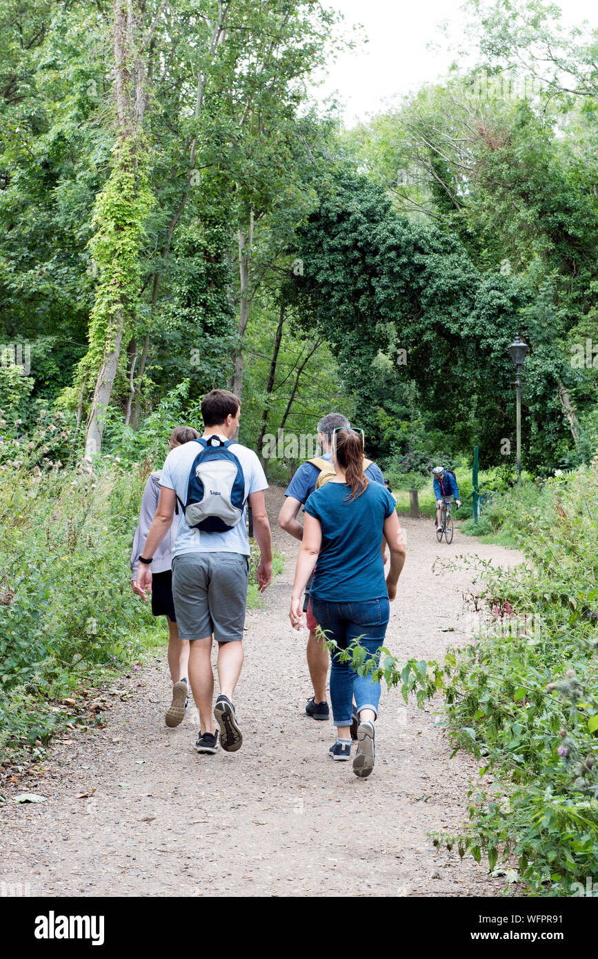 People walking along the Parkland Walk a disused railway line now an urban nature reserve Stock Photo