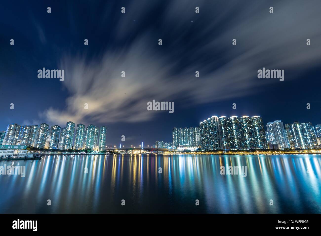 Buildings With Sea Reflection At Night Stock Photo