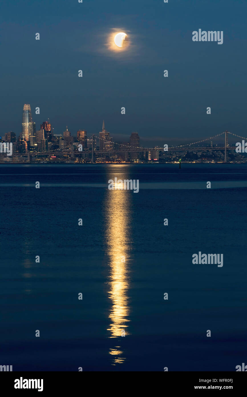 Lunar eclipse over city skyline hi-res stock photography and images - Alamy