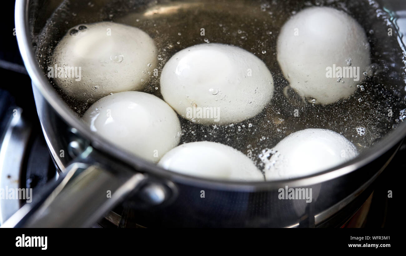 High Angle View Of Eggs Boiling In Water Stock Photo