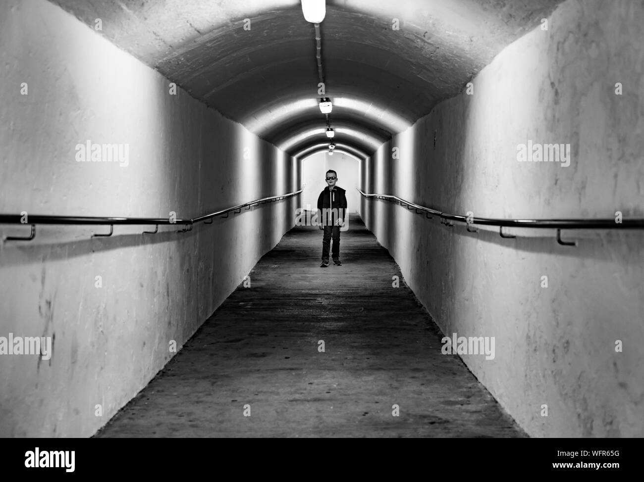Boy Walking In Tunnel Stock Photo Alamy