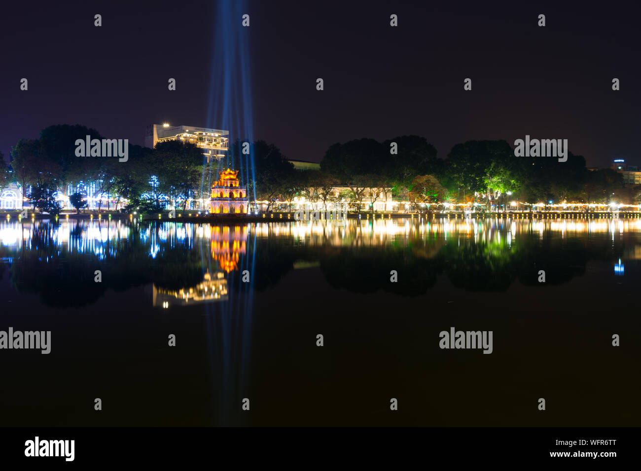 Reflection Of Illuminated Turtle Tower In Hoan Kiem Lake At Night Stock Photo