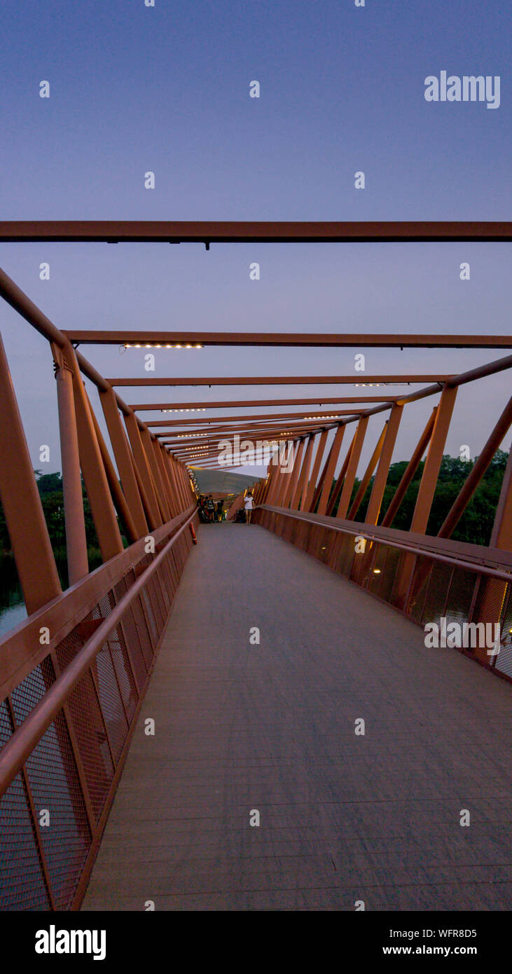 Footbridge Over River Against Sky At Dusk Stock Photo