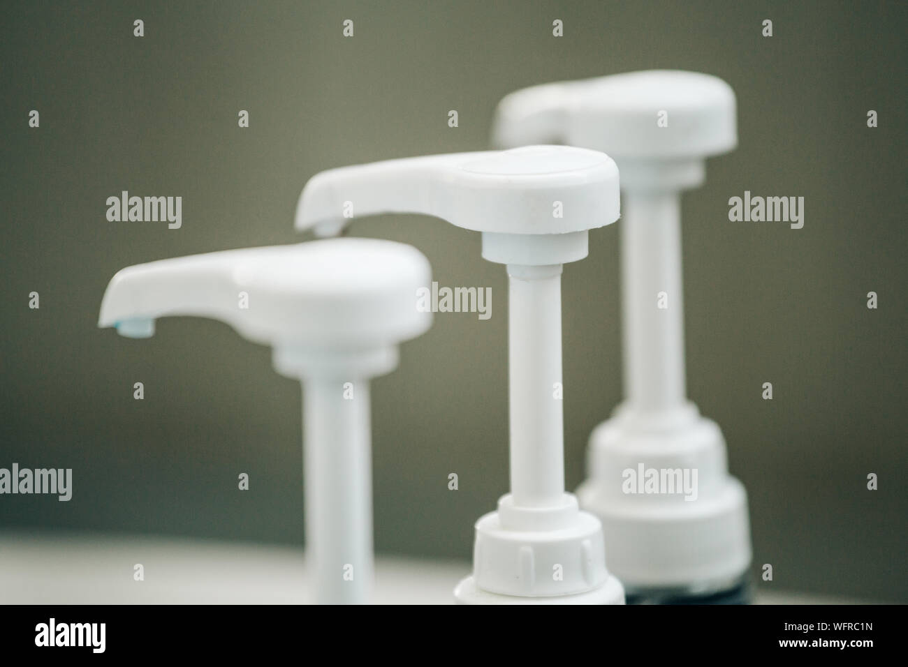 Close-up Of Soap Dispensers In Bathroom Stock Photo