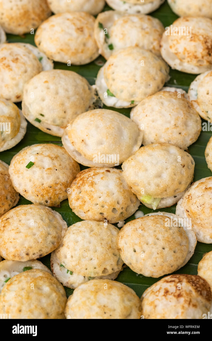 Traditional thai street food dessert, Kanom Krok or coconut rice pancakes. Stock Photo