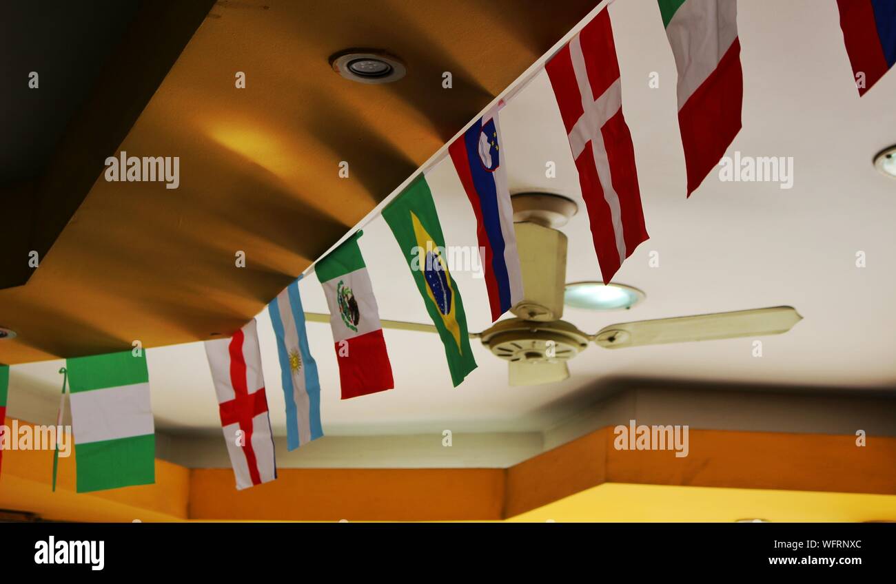 Low Angle View Of Various Flags Hanging To Ceiling Stock