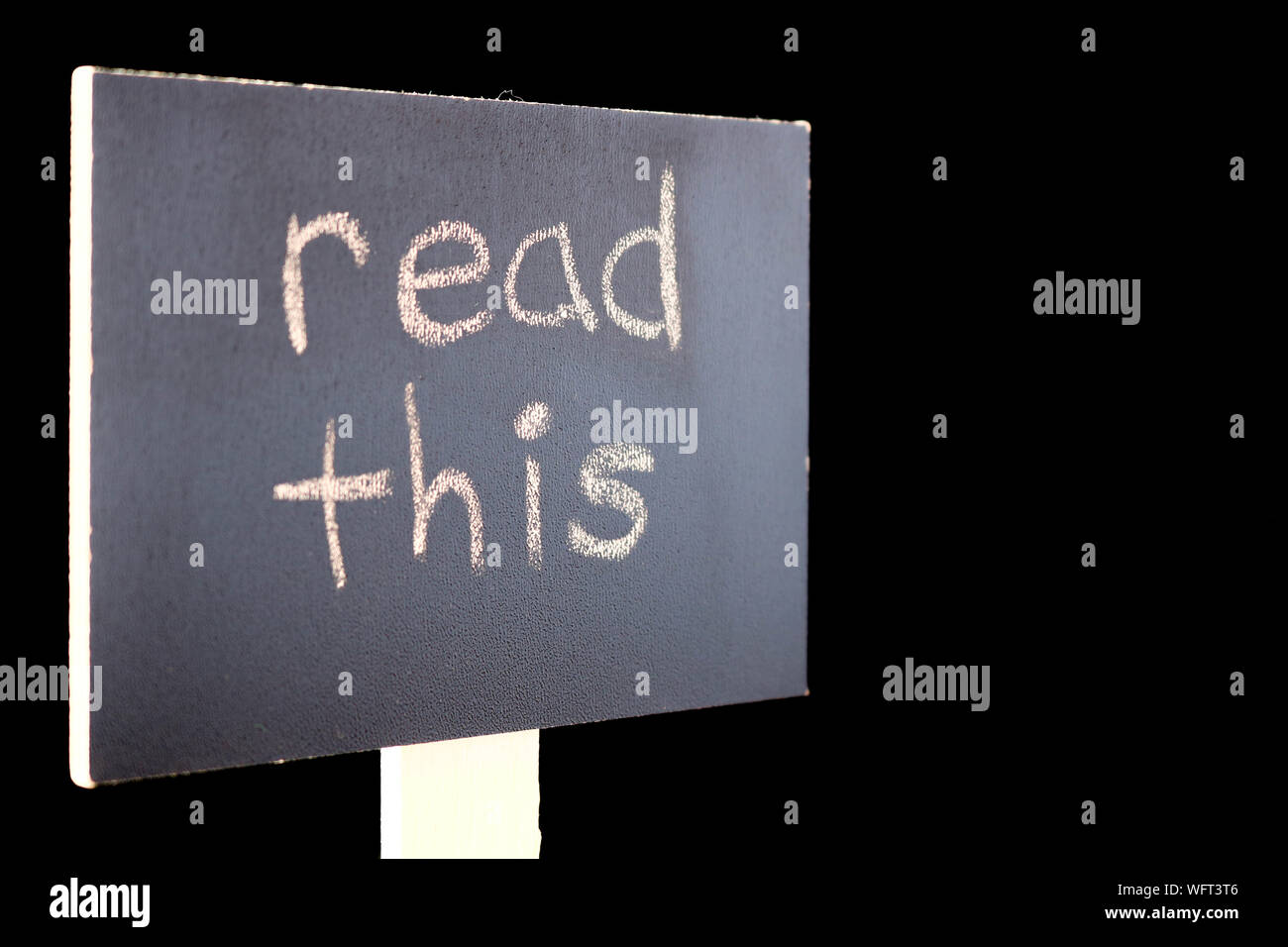 Close-up Of Text Board Against Black Background Stock Photo