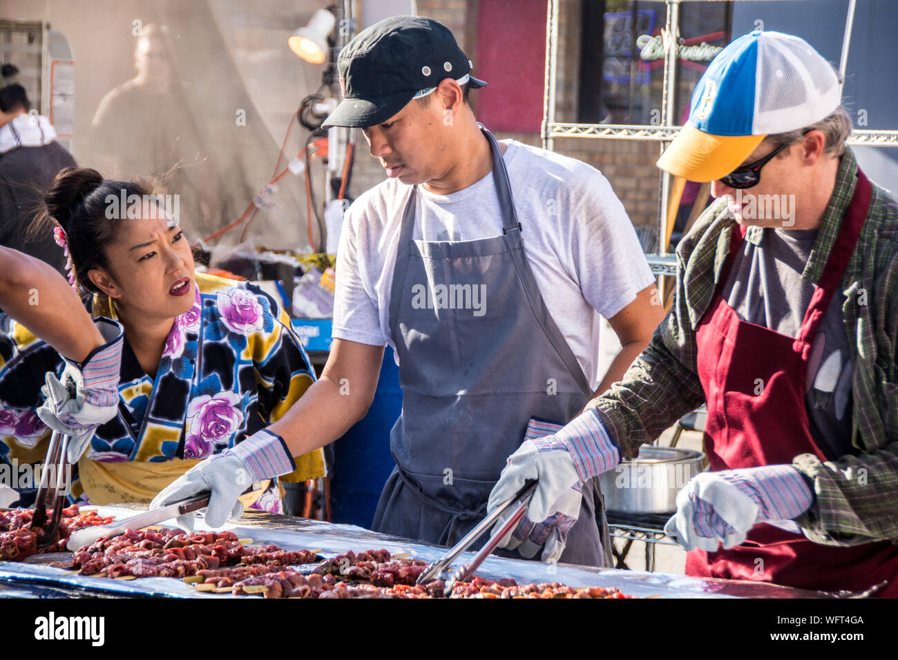 A group of volunteers cooking Korean food, at the Orange County