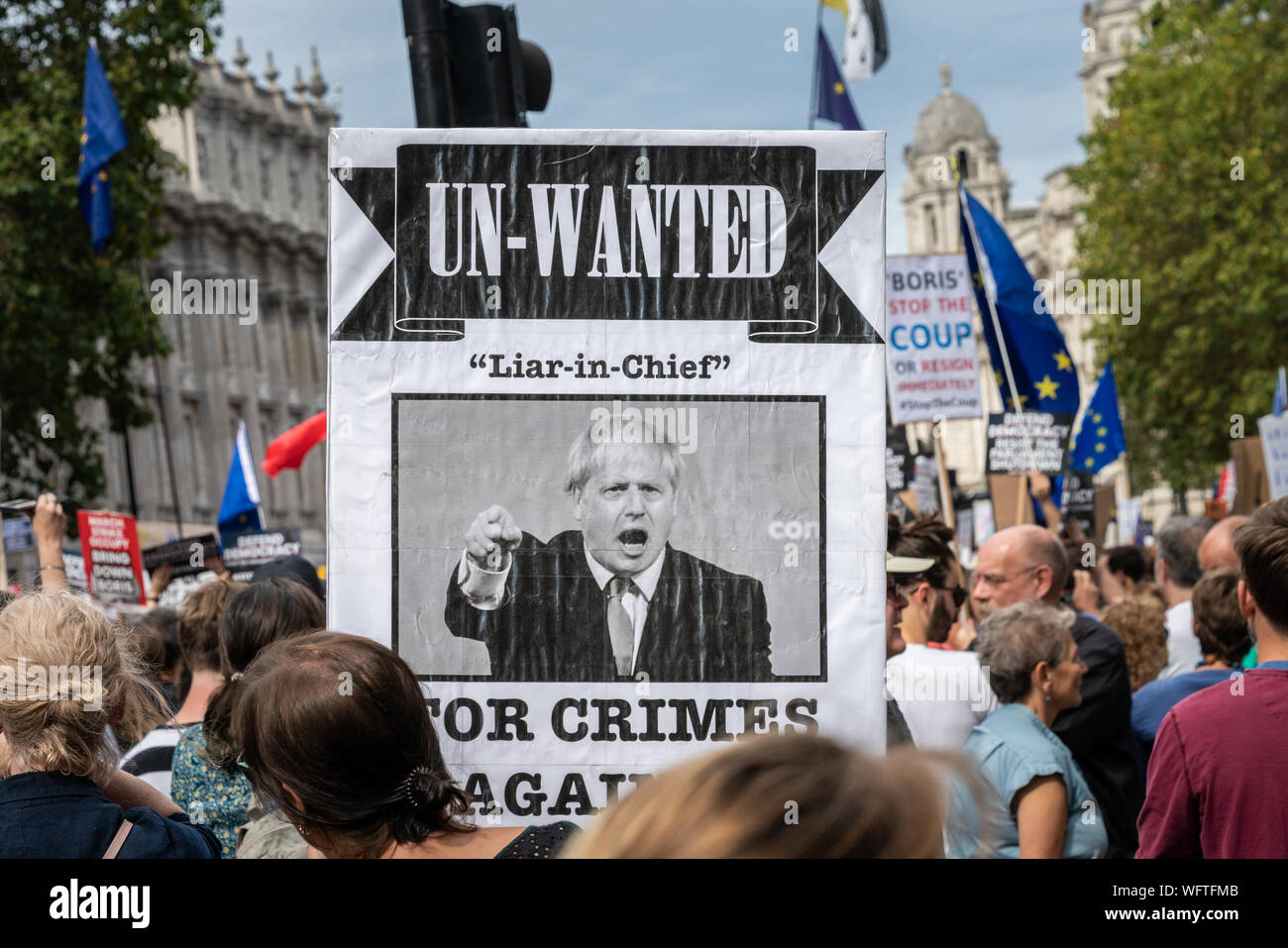 31th Aug 2019 - London, UK. An Anti-Brexit protesters hold up a placard of Boris Johnson reading 'Un-Wanted' outside Downing street at Whitehall. Stock Photo
