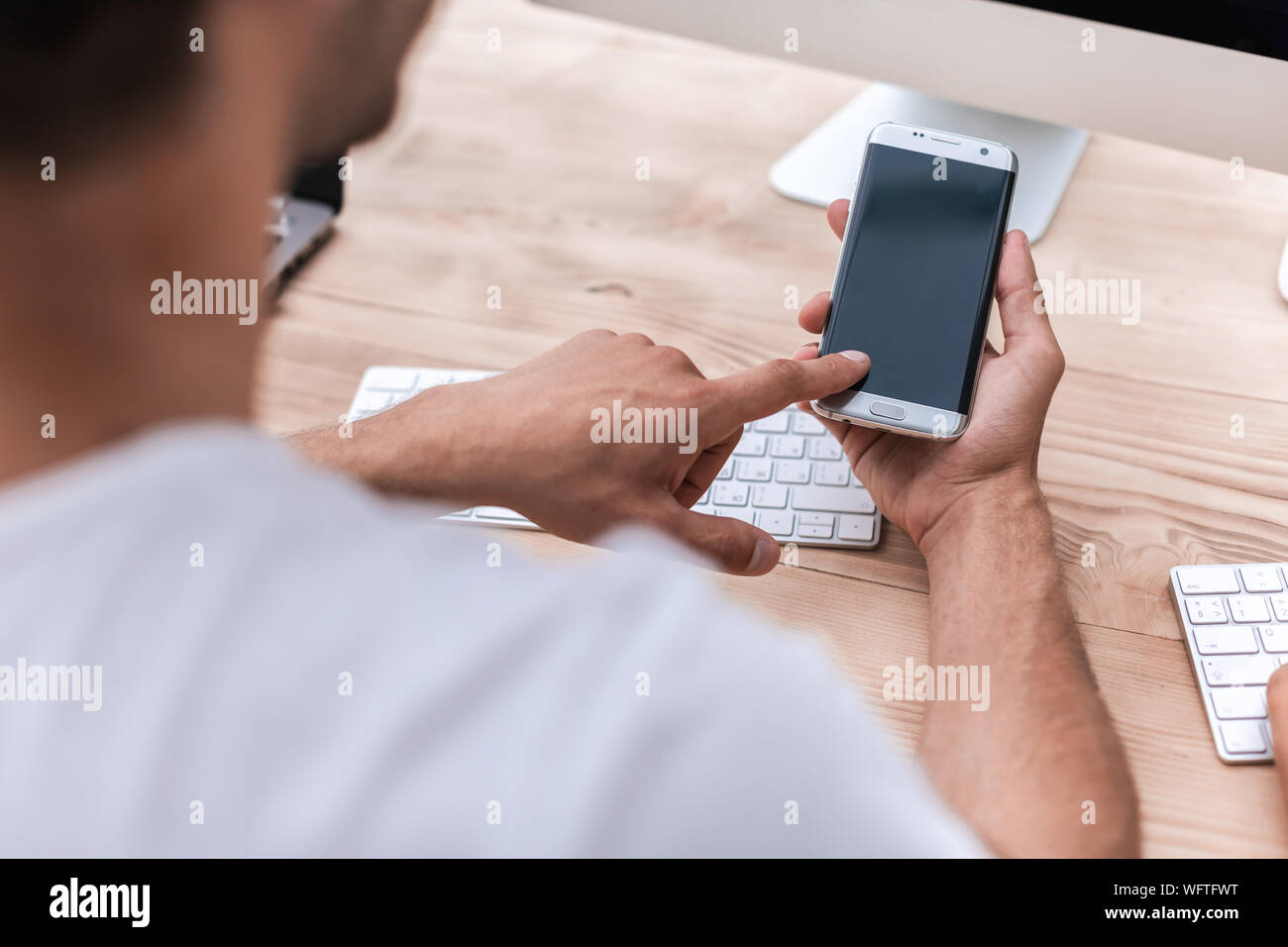 Manager uses smartphone sitting hi-res stock photography and images - Alamy