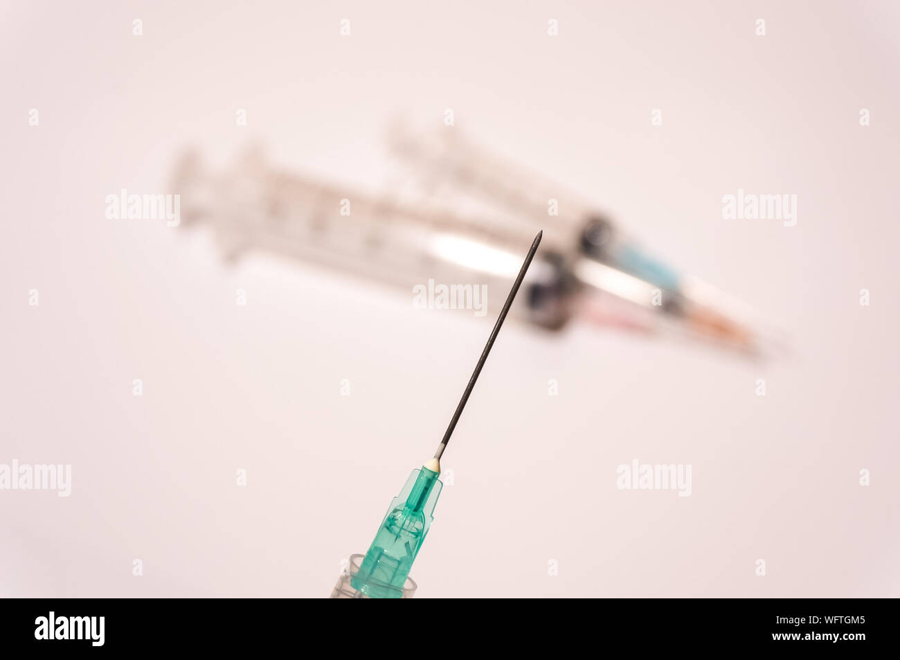 Close-up Of Injections Against White Background Stock Photo