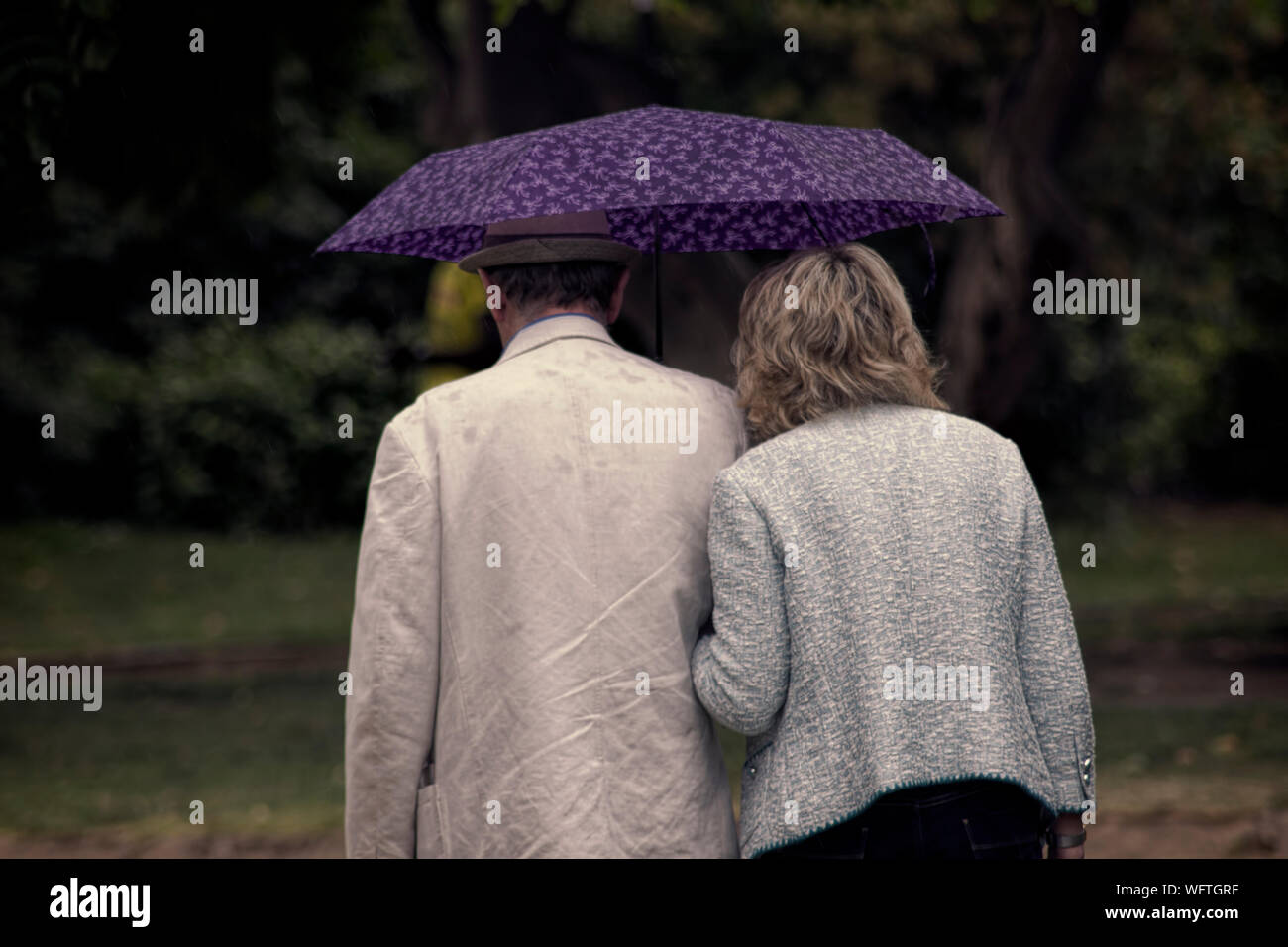 Couple umbrella walking in park hi-res stock photography and images - Alamy