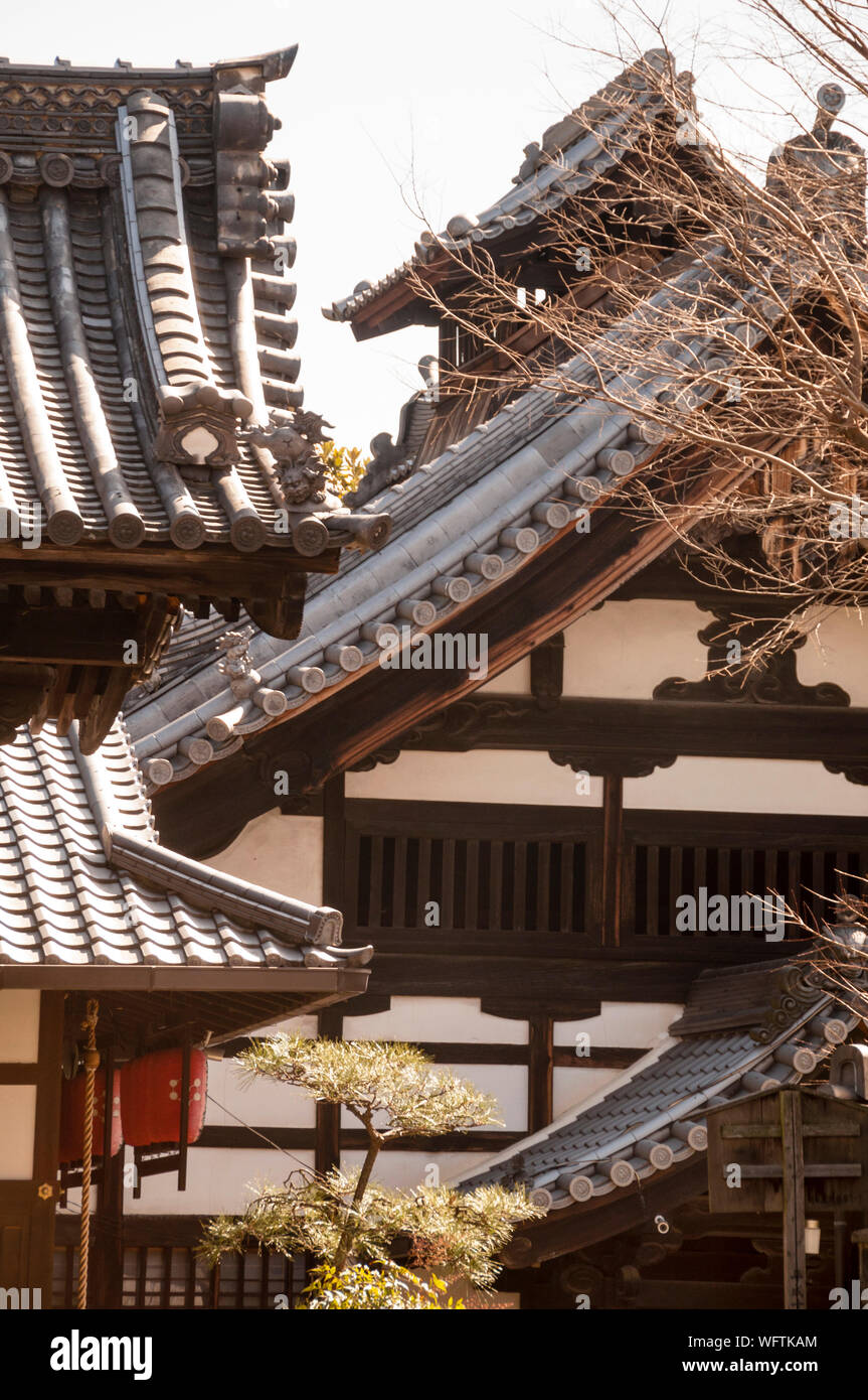 Japanese hipped roofs are curved to ward off evil spirits and to allow more light to enter. Stock Photo