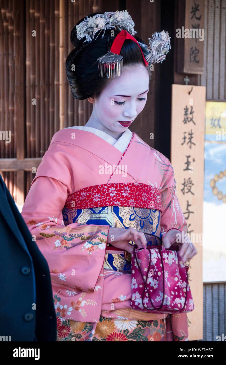 Japanese geiko wearing a traditional formal kimono and white oshiroi makeup  in Kyoto, Japan Stock Photo - Alamy