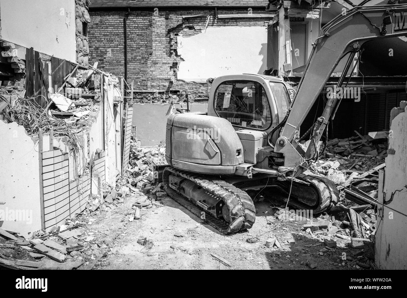 Bulldozer Demolishing Houses Stock Photo