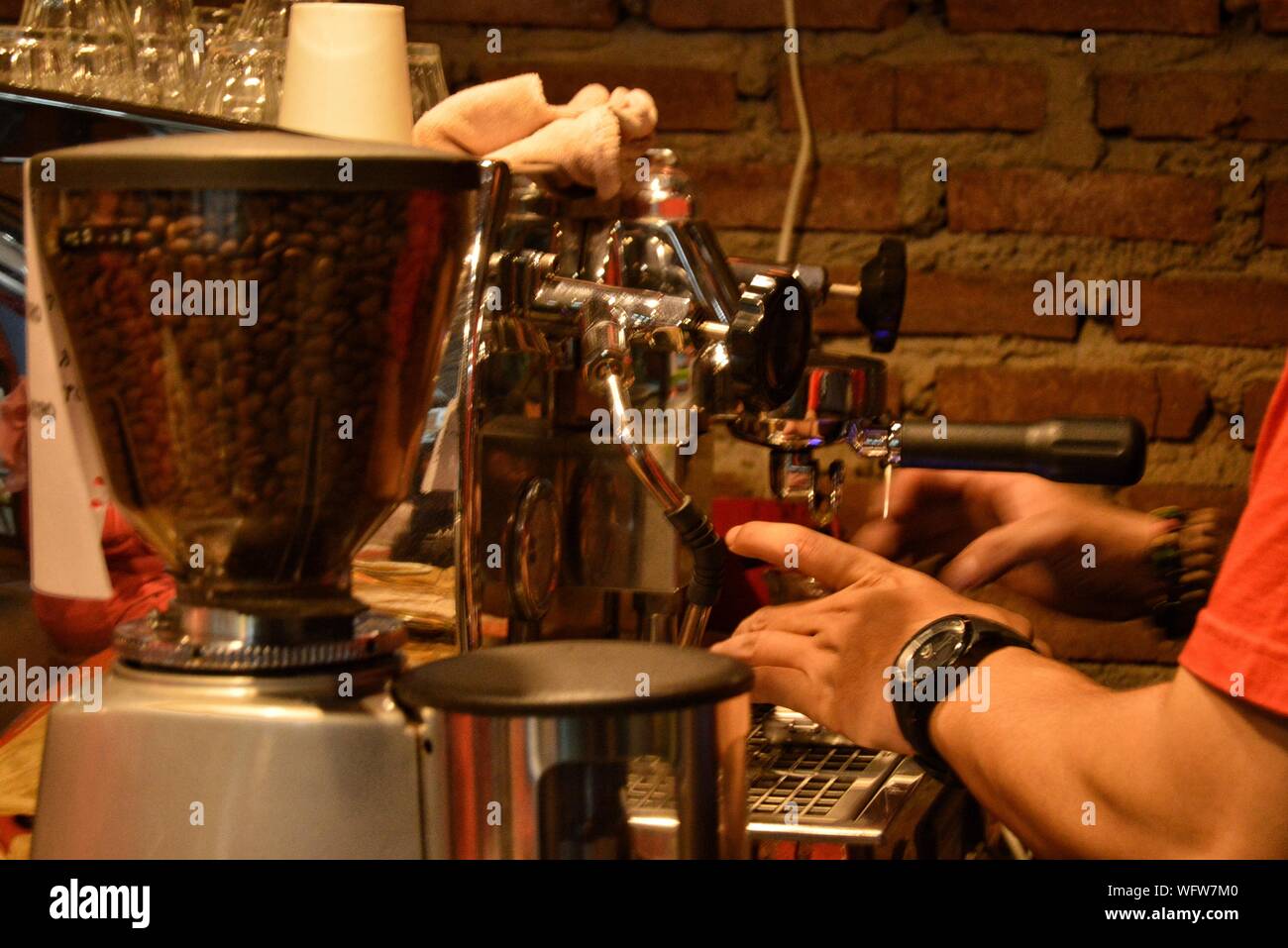 Cropped Hands Of Man Working In Cafe Stock Photo