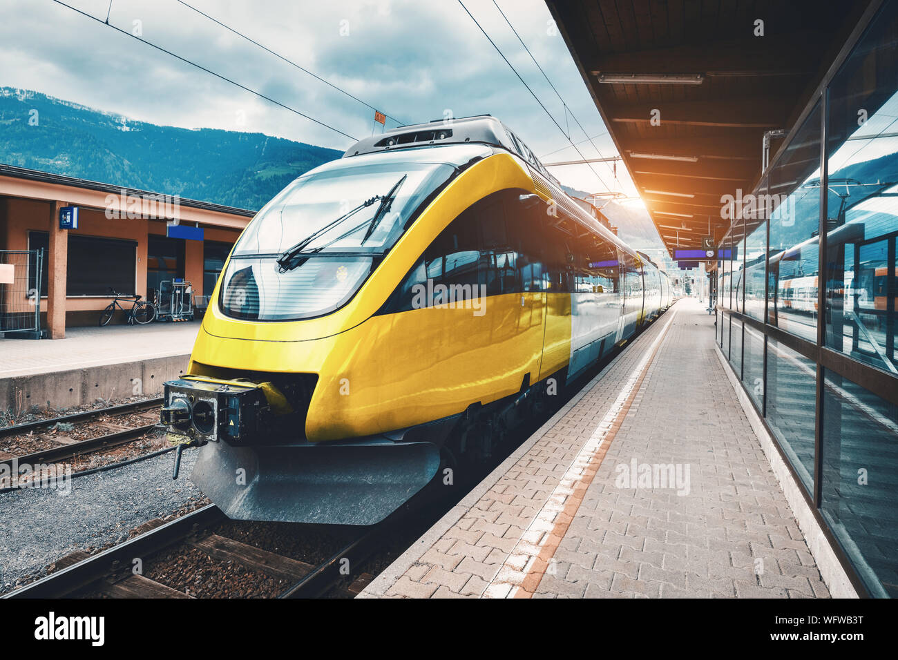 Beautiful high speed train on the railway station in mountains Stock Photo