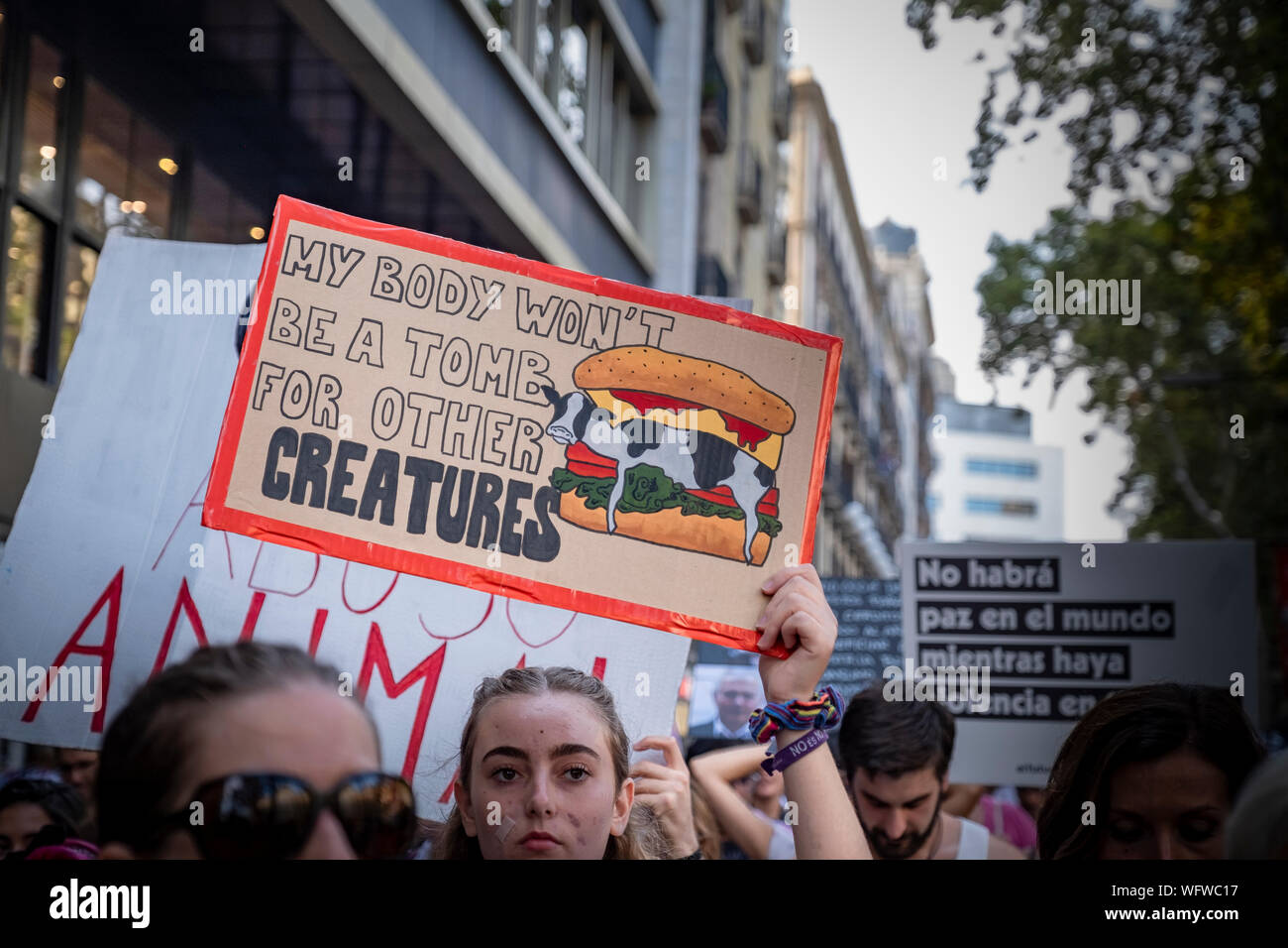 A protester holds a placard in defence of  the animal rights during the demonstration.Convened by the Barcelona Animal Save organisation hundreds of people have demonstrated in defence of animal rights and a vegan diet. Stock Photo