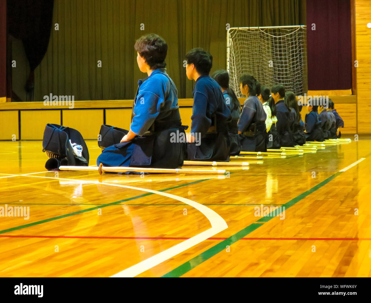 Martial Art Student Sitting In Row Learning Principles Of Self Defence Art Stock Photo