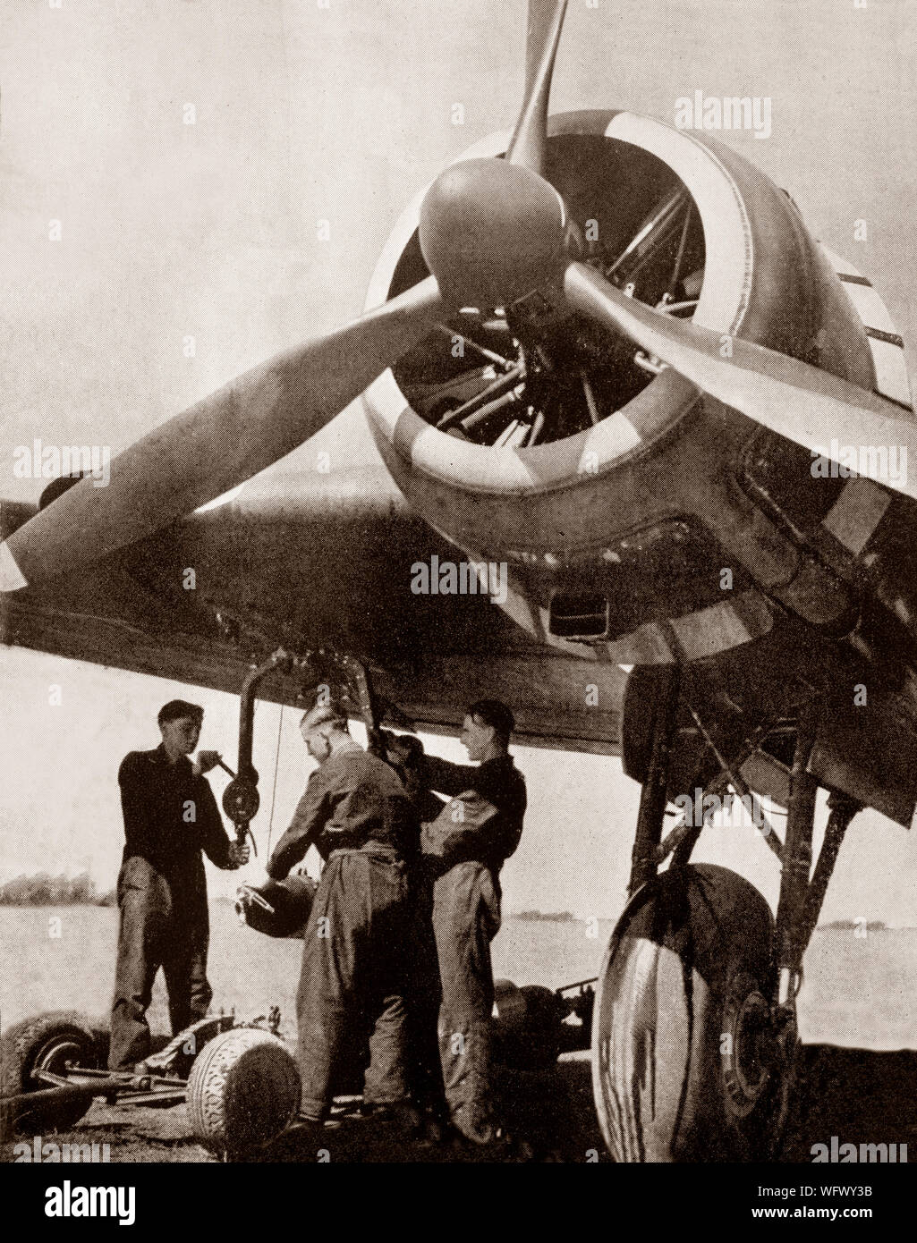 Bombs being loaded onto a Handley Page HP.52 Hampden,  a British twin-engine medium bomber of the Royal Air Force, often referred to by aircrews as the 'Flying Suitcase' because of its cramped crew conditions. It served in the early stages of the Second World War, bearing the brunt of the early bombing war over Europe, taking part in the first night raid on Berlin and the first 1,000-bomber raid on Cologne. It was retired from RAF Bomber Command service in late 1942, superseded by the larger four-engined heavy bomberslike the Avro Lancaster. Stock Photo
