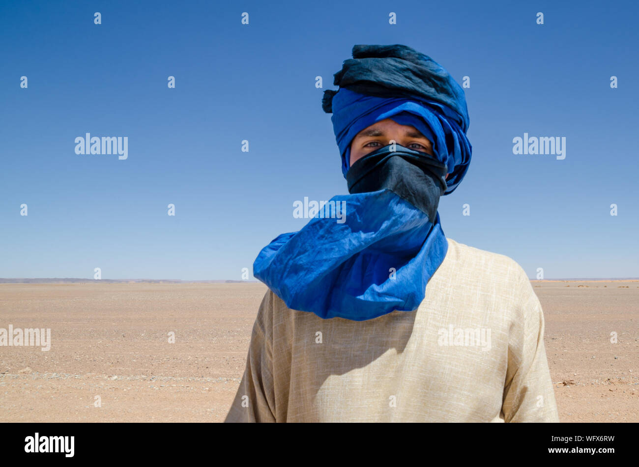 Portrait Of Man Wearing Headscarf At Desert Stock Photo Alamy