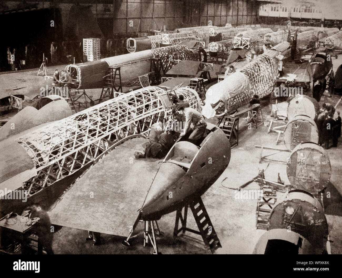 The production line of Vickers-Armstrong Wellington, twin-engined, long-range medium bomber. It was designed during the mid-1930s  by Vickers-Armstrongs' chief designer Rex Pierson; a key feature of the aircraft is its geodetic airframe fuselage structure that gave strength and lightness, principally designed by Barnes Wallis. With a flurry of order and production having been assured by the end of 1937, Vickers set about simplifying the manufacturing process of the aircraft and announced a target of building one Wellington per day. Stock Photo