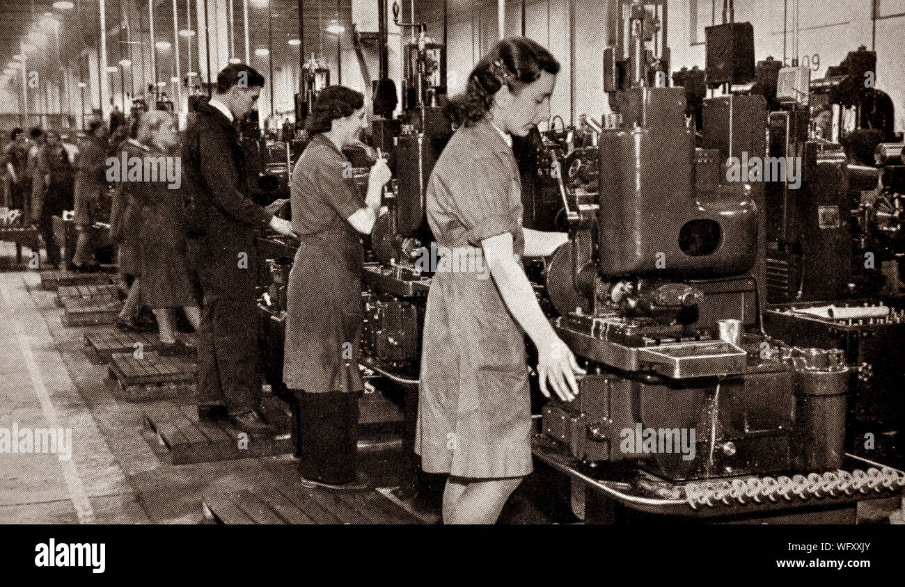 Factory staff, men and women, making parts for the Bristol Hercules, 14-cylinder two-row radial aircraft engine designed by Sir Roy Fedden and produced by the Bristol Engine Company starting in 1939. It was the first of their single sleeve valve (Burt-McCollum, or Argyll, type) designs to see widespread use, powering many aircraft in the mid-World War II timeframe. Stock Photo