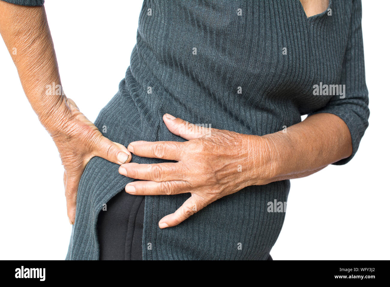 Midsection Of Senior Woman Suffering From Pain Against White Background Stock Photo