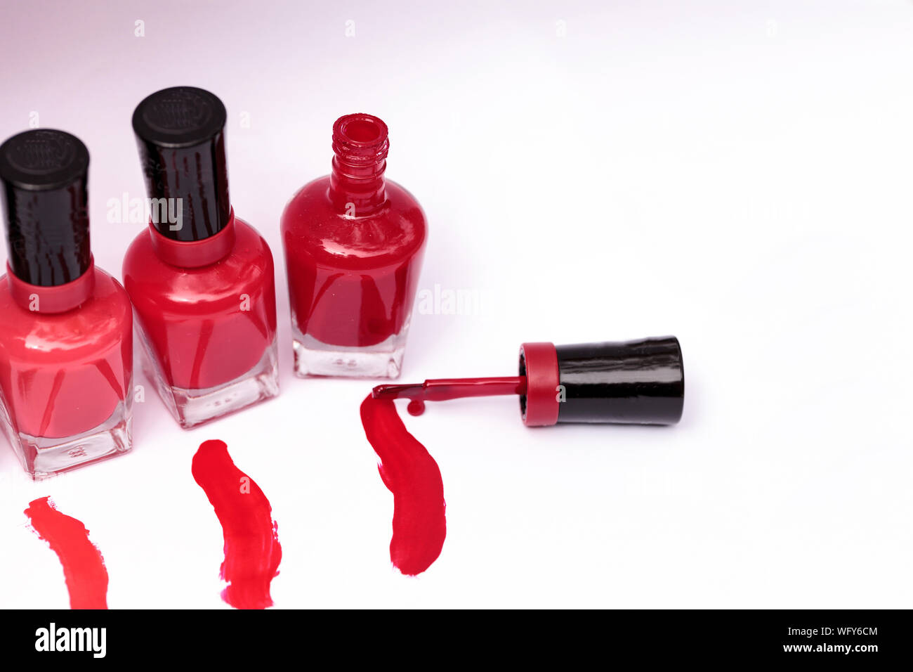 High Angle View Of Nail Polish Bottles Over White Background Stock Photo