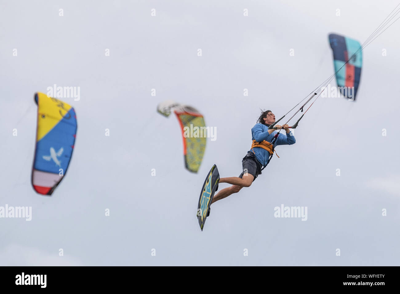 USA. 31st Aug, 2019. A kite boarder catches air as strong winds reach the Atlantic coast of Charleston ahead of Hurricane Dorian on Saturday, August 31, 2019 in Sullivans Island, South Carolina. The category 4 storm is expected to hit the Bahamas and then move north along the Eastern Seaboard. Credit: UPI/Alamy Live News Stock Photo
