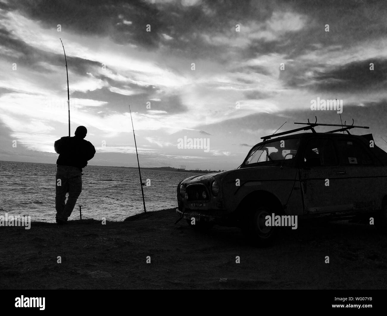 Silhouette Of Man Fishing Black and White Stock Photos & Images - Alamy