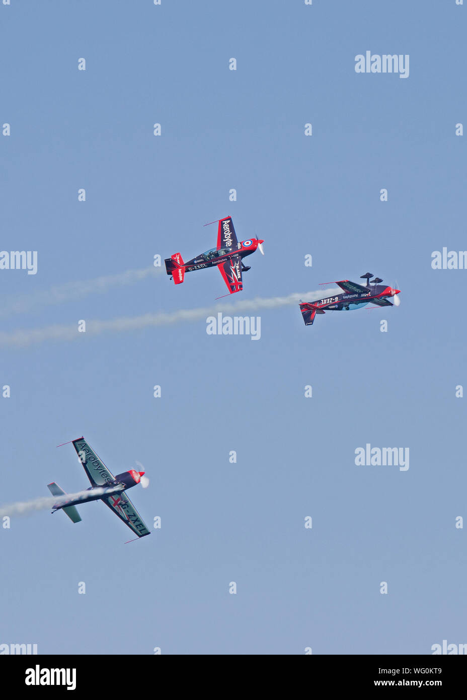 Three of the Blades Aerobatics Team perform this amazing stunt for the crowds at Eastbourne's International Airshow in August 2018. Stock Photo