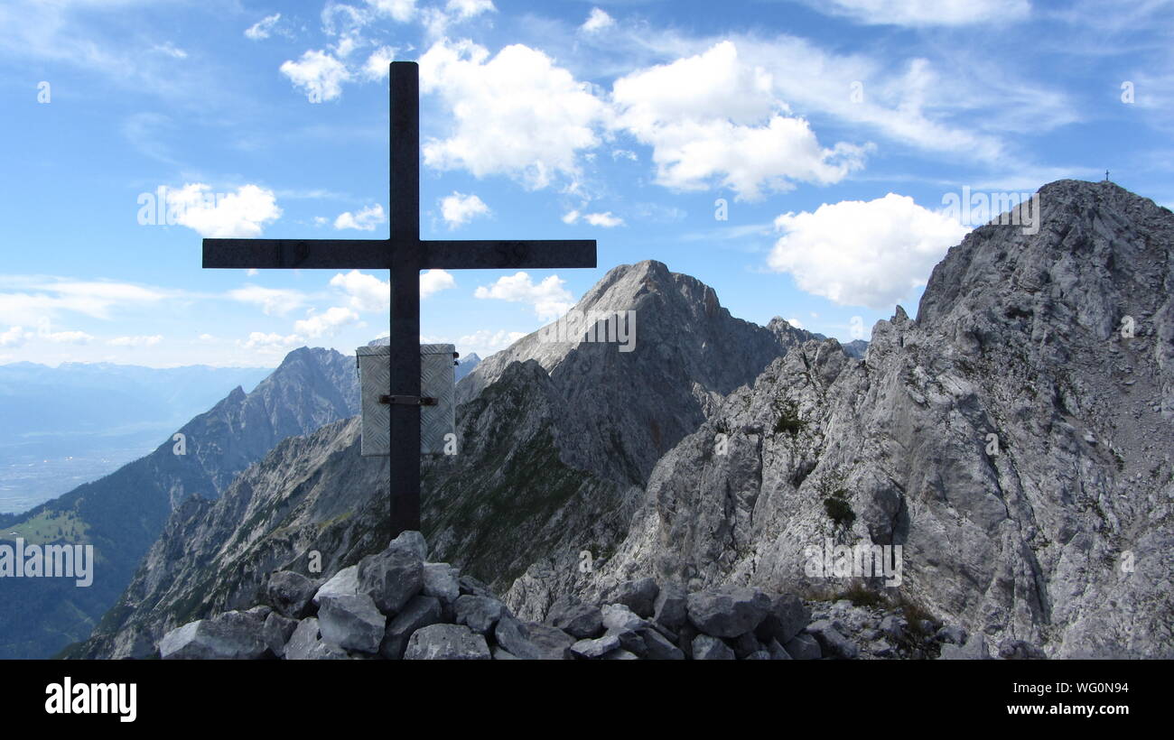 Cross On Mountain Against Sky Stock Photo