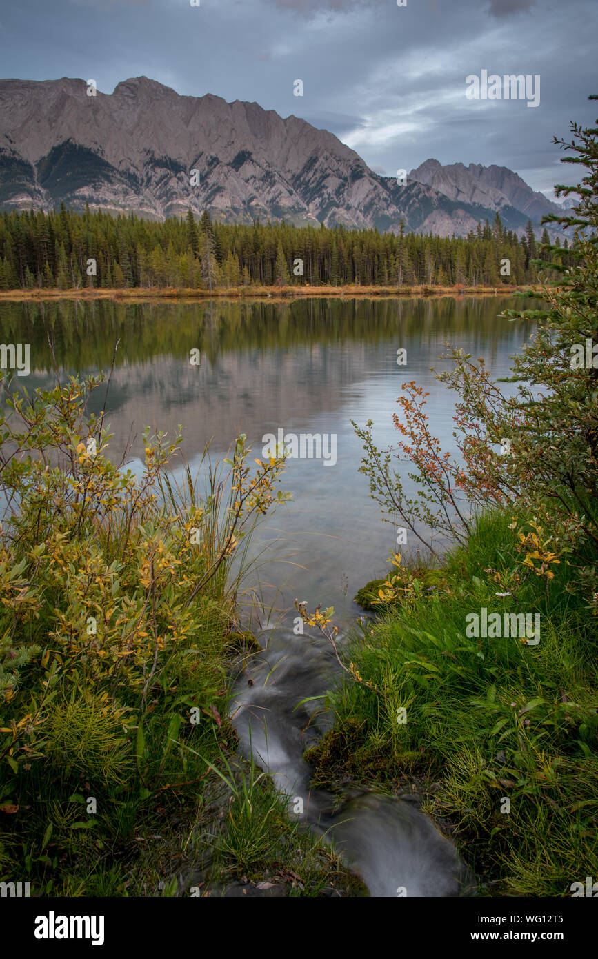 Mountains reflecting in the calm waters of Spillway Lake in Peter Lougheed Provincial Park, Alberta, Canada Stock Photo