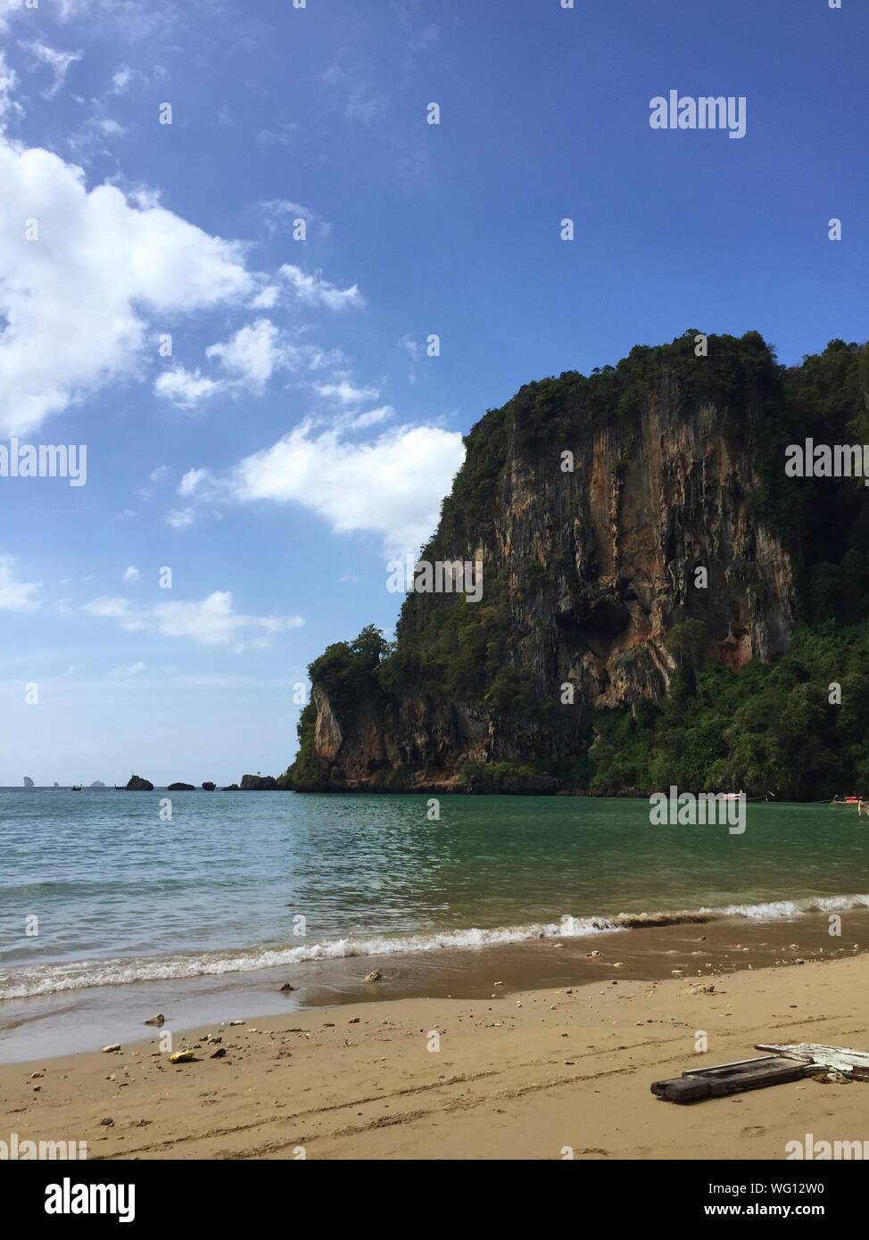 Huge Rock Against Blue Sky At Paradise Beach Stock Photo