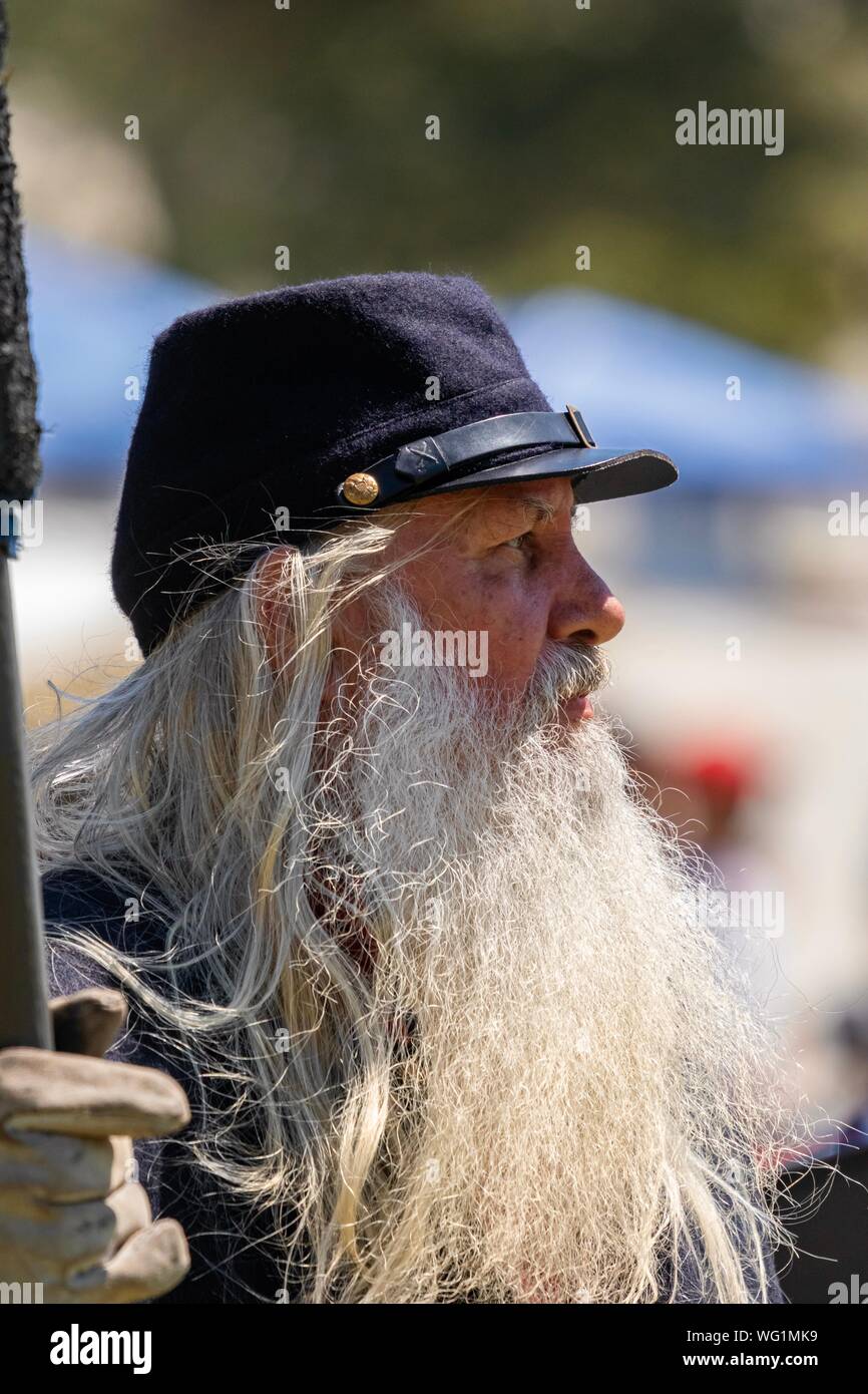 Portrait of a man with a long white beard is dressed as a union soldier during an American Civil War reenactment Stock Photo