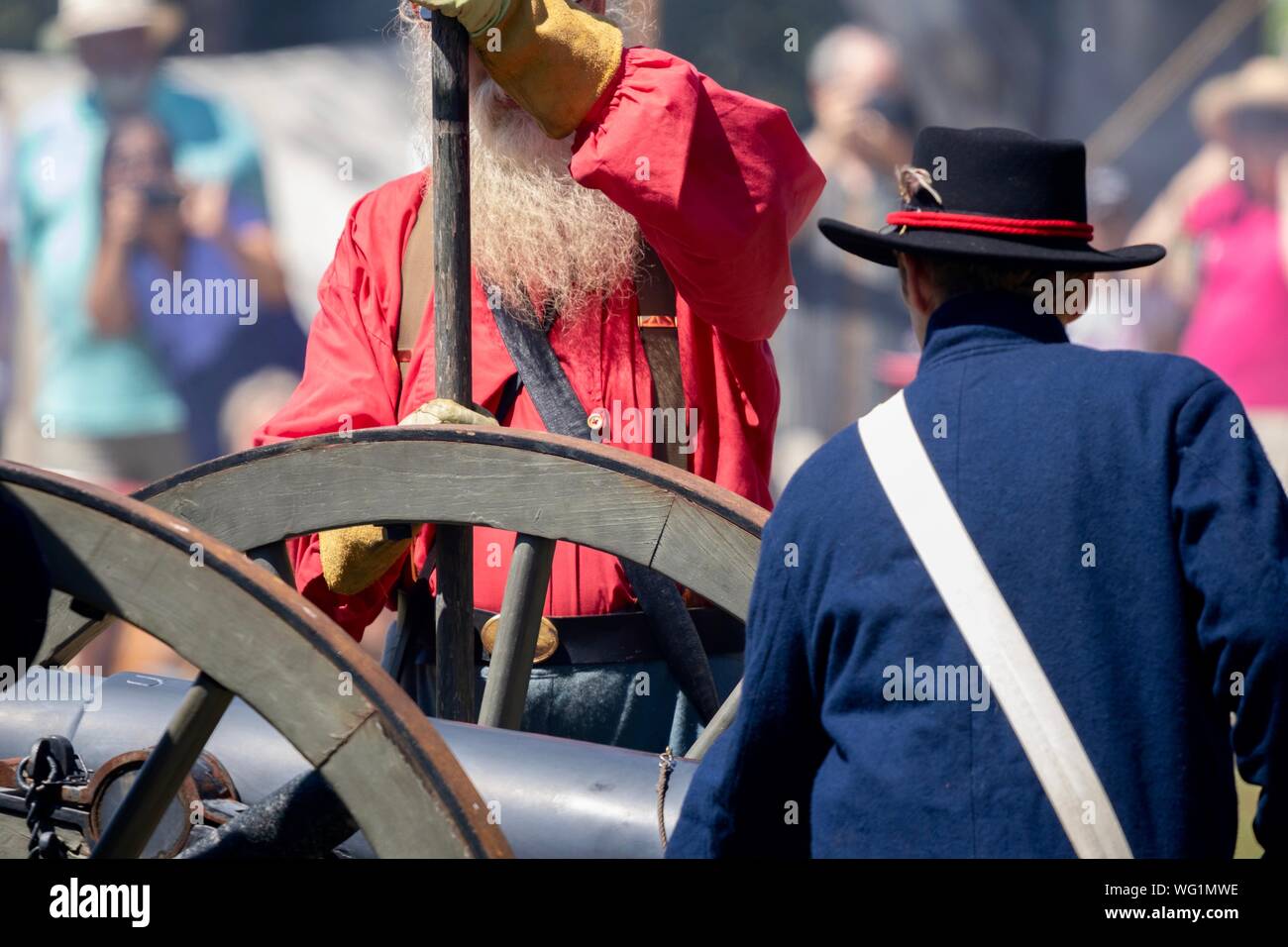 Man dressed in civil war era clothing by a canon during a Civil War reenactment Stock Photo