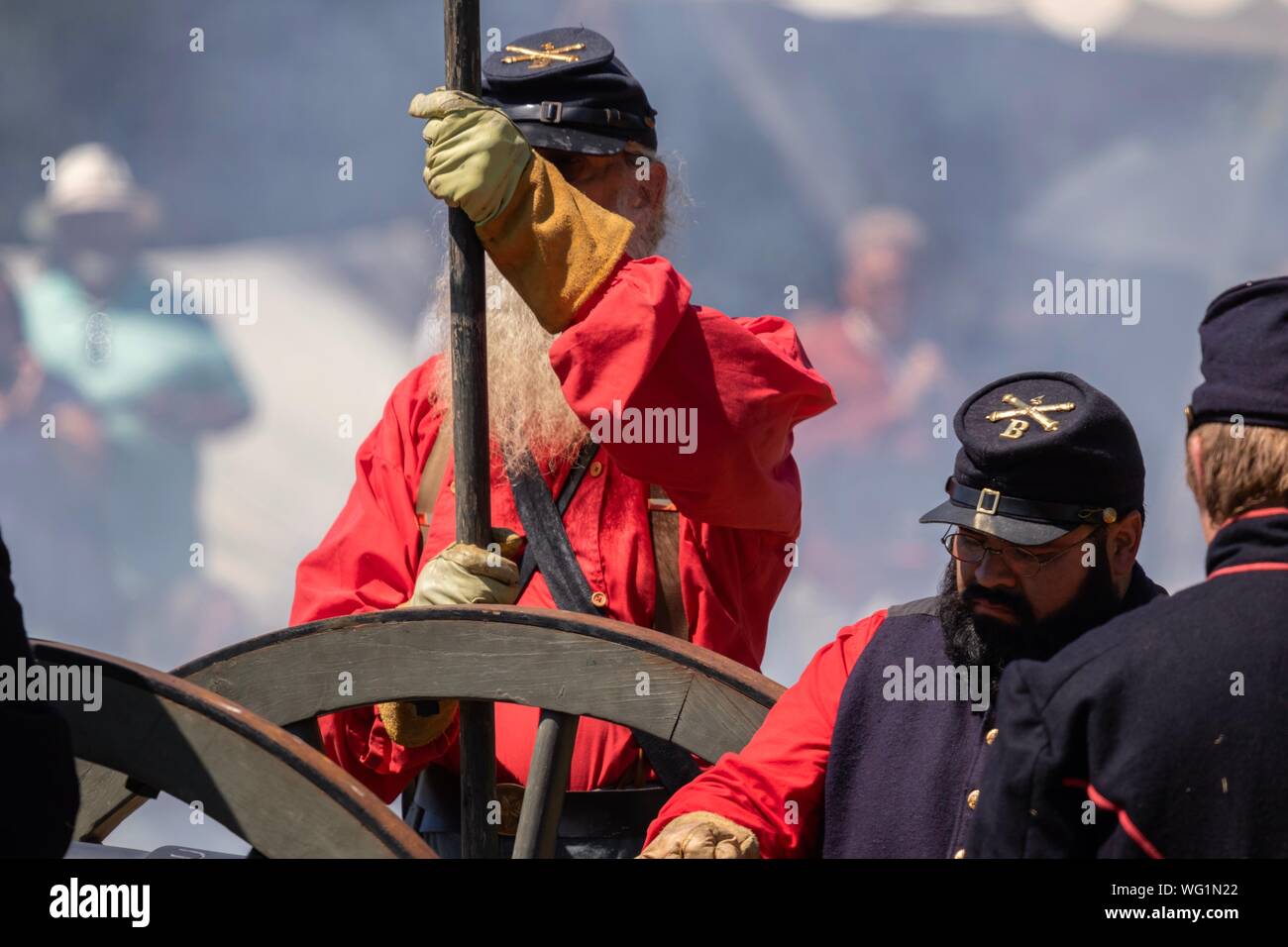 Man dressed in civil war era clothing by a canon during a Civil War reenactment Stock Photo