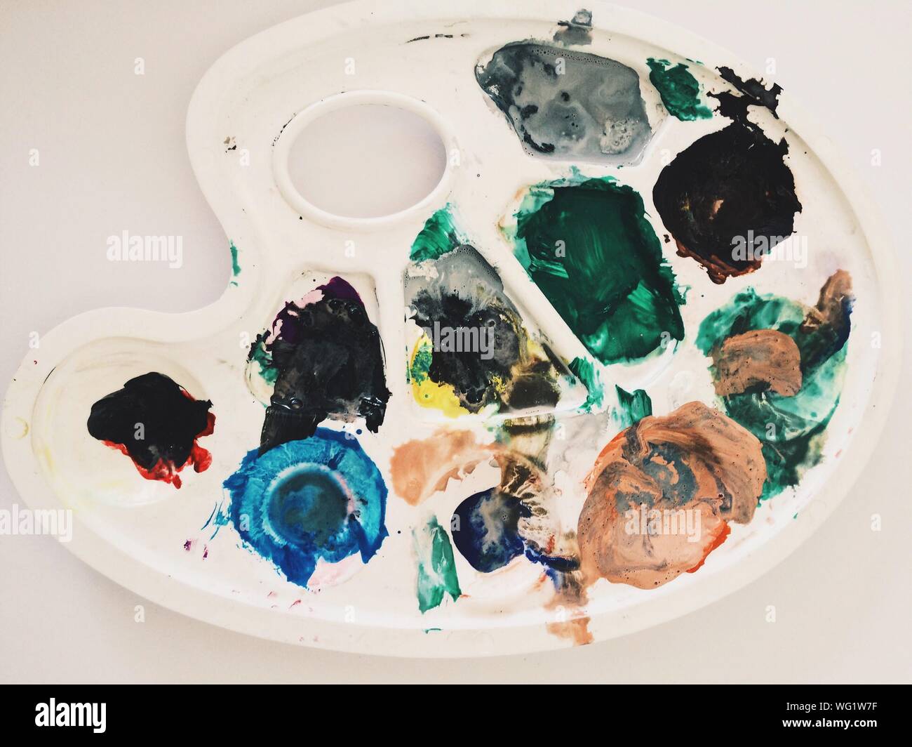 Close-up Of Multi Colored Paints In Palette On Table Stock Photo