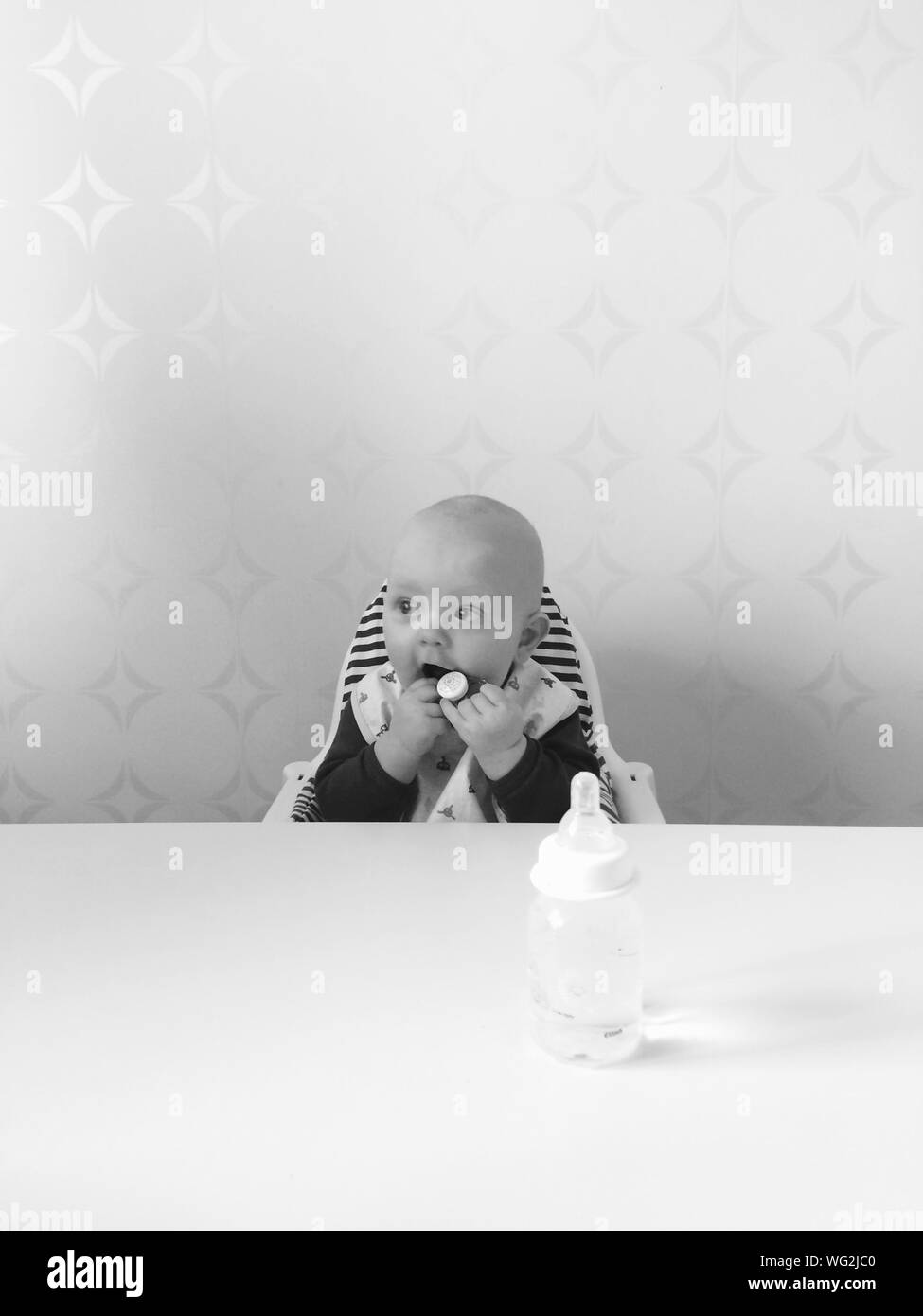 Baby Sitting In High Chair At Home Stock Photo Alamy