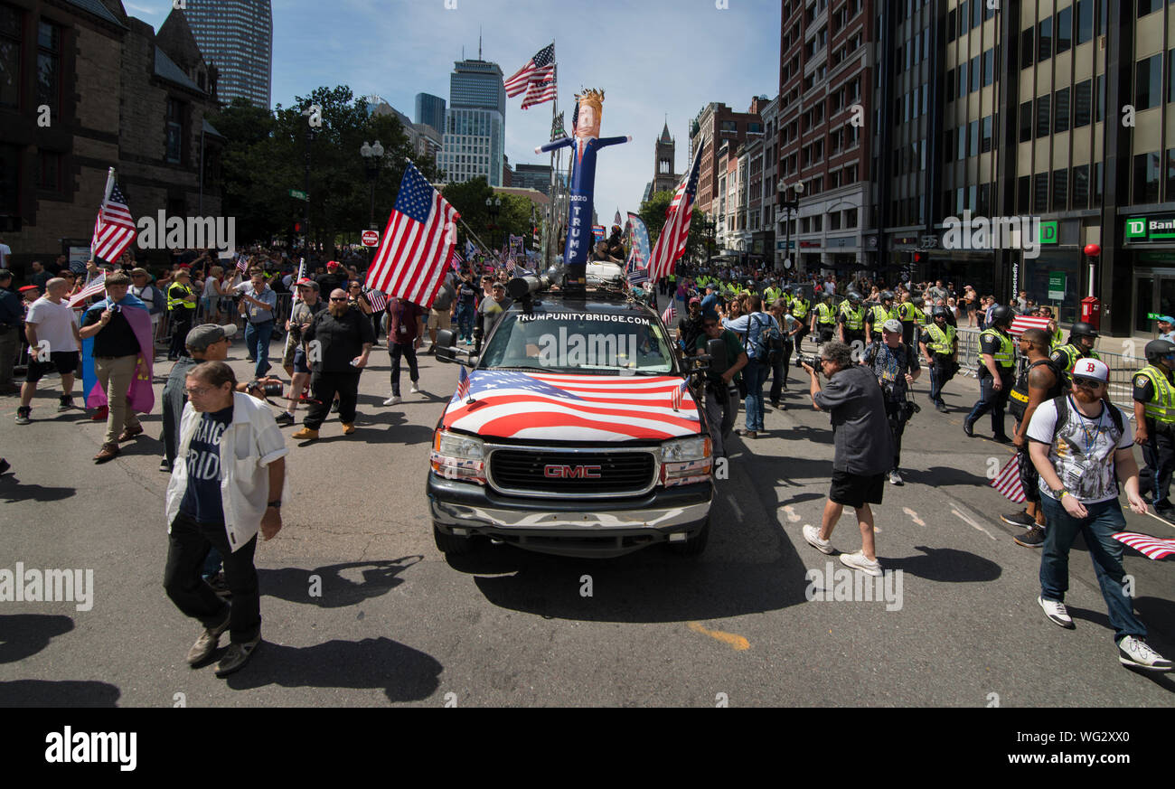 Boston, MA, USA.  31st August 2019.  Hundreds took part in the Straight Pride Parade through central Boston, MA.  The Straight Pride marchers, supporters of U.S. President Donald Trump, were outnumbered by anti-Trump and gay rights supporters who lined the streets along the Straight Pride march from Copley Square to Boston City Hall Plaza.  Hundreds of Boston Police separated the marchers from the anti-straight pride counter demonstrators along the parade route and at City Hall Plaza. Photo shows  truck leading the march with an inflatable Trump on top. Credit: Chuck Nacke / Alamy Live News Stock Photo
